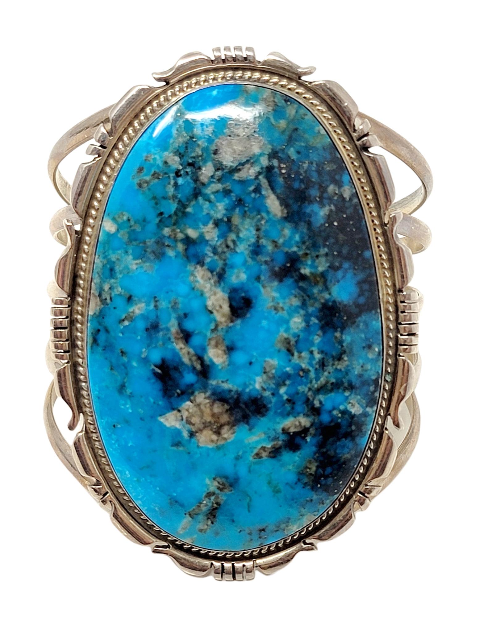 Huge sterling silver and natural turquoise cuff bracelet with exquisite fine details. Handmade by Native American artist Jon McCray. 

Bracelet type: Cuff
Metal: Sterling Silver
Natural Turquoise: Cabochon
Weight: 106.5 grams
Width: 3