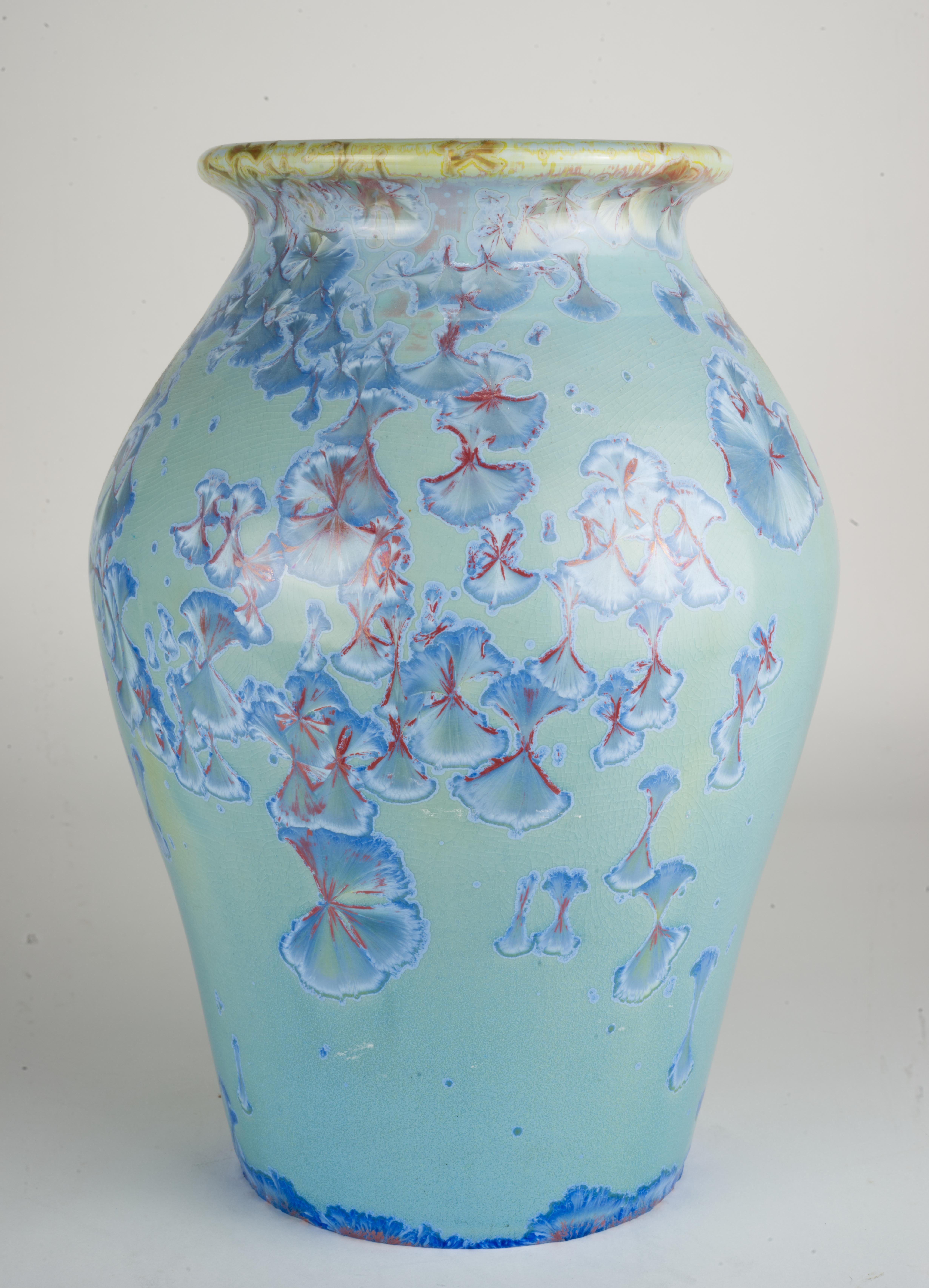  Rare, sculptural vase was made of pure, high-fire porcelain and glazed both on the inside and the outside. Blue and pink highly detailed crystals on crackled blue background were grown in a kiln during a very long, controlled firing. Each