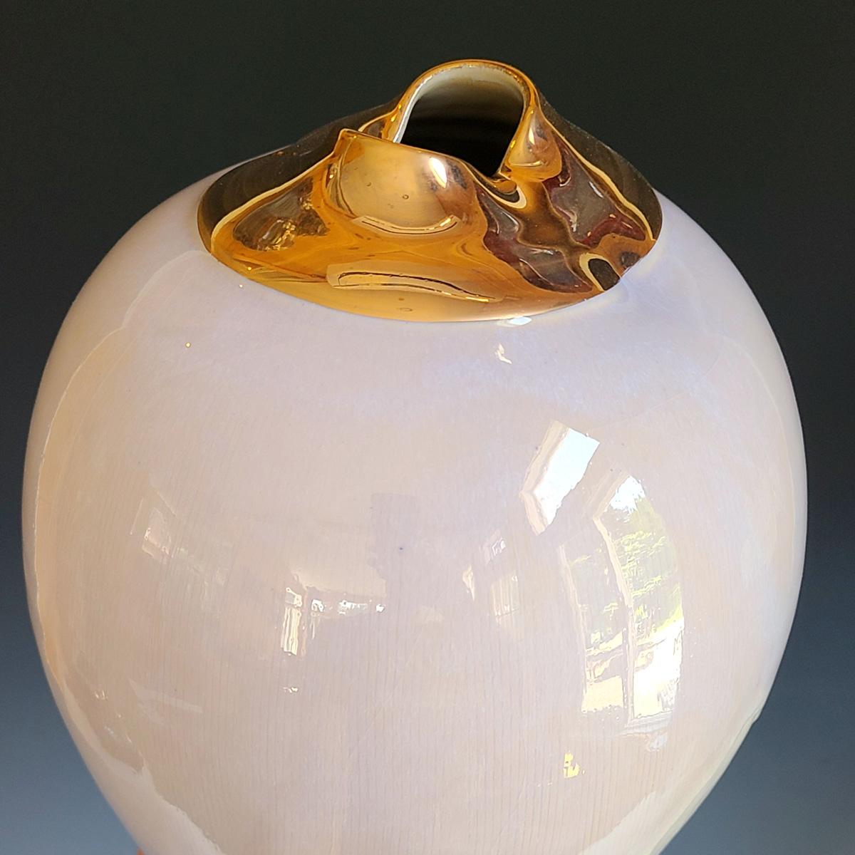Cette sculpture vase en porcelaine émaillée de Jon Puzzuoli présente un corps blanc avec une moitié inférieure texturée et un col fini avec un lustre d'or 18K. Le cachet de l'artiste se trouve à la base de la sculpture.

Jon Puzzuoli est un