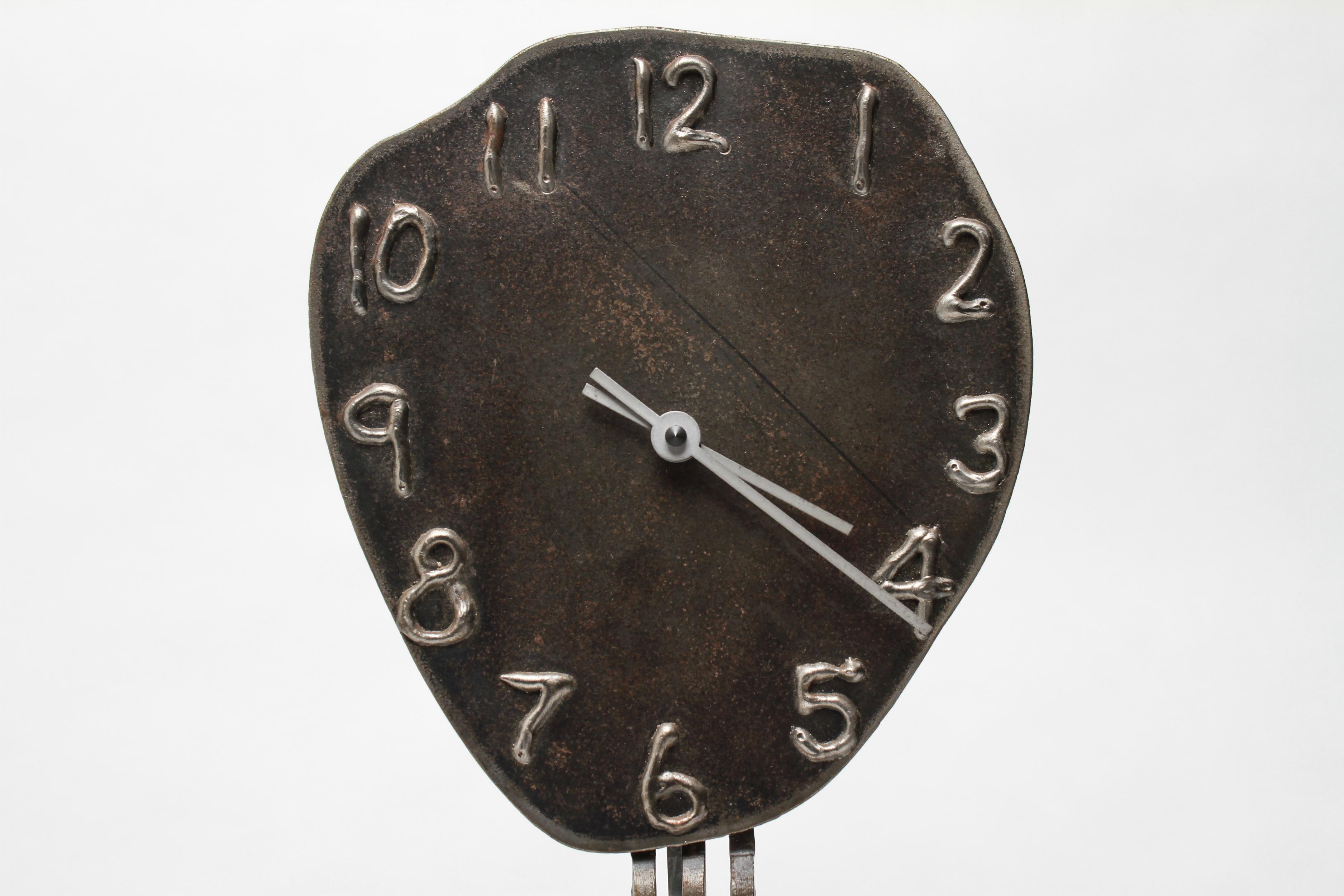 American Postmodern metal clock with pendulum designed in the 1990s by Jon Sarriugarte for Form and Reform in California. The piece is signed and marked on the reverse 