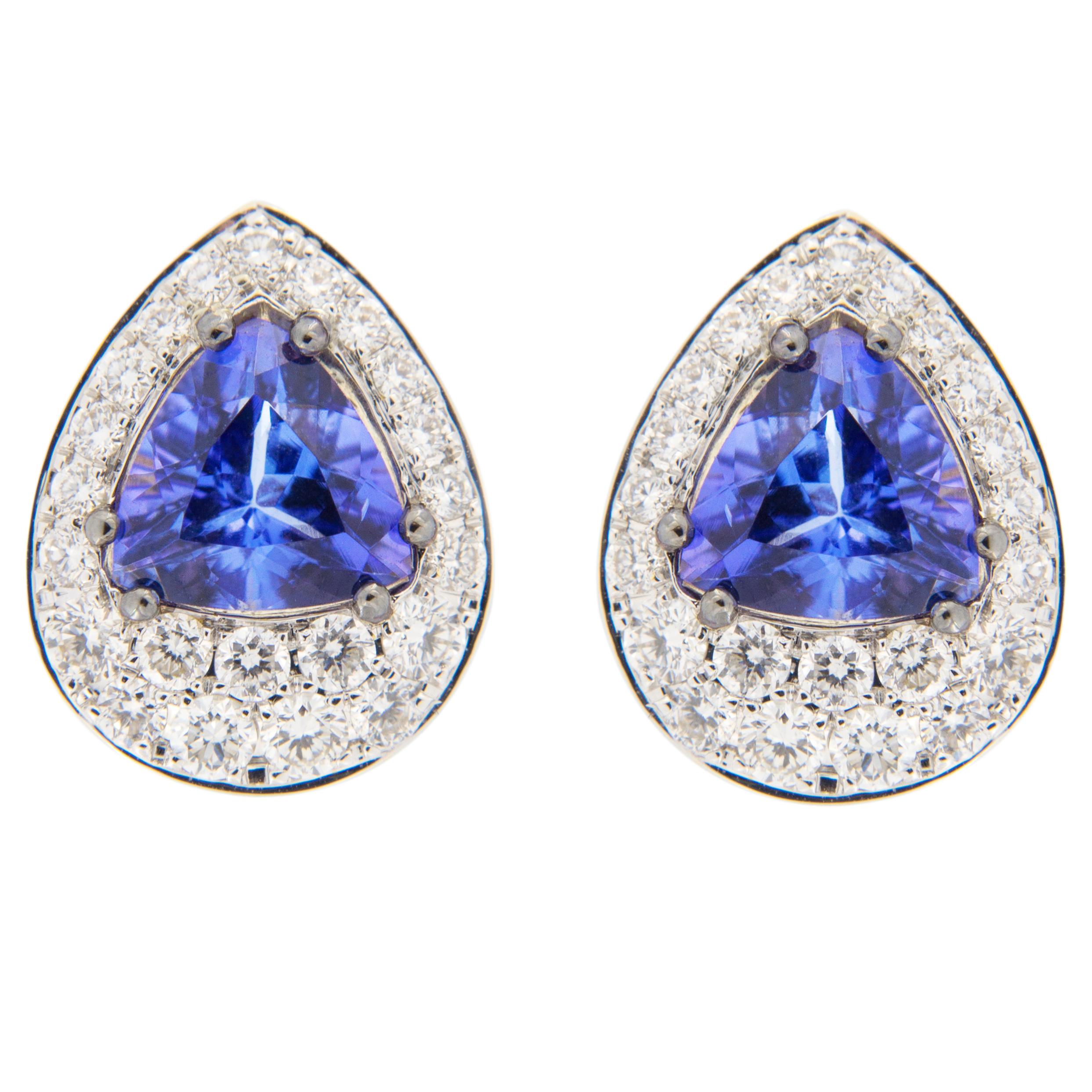 Jona design collection, hand crafted in Italy, 18 karat white and yellow gold stud earrings set with two triangle cut Tanzanite weighing 1.35 carats, surrounded by 44 brilliant cut white diamonds, F color, VVS1 clarity, weighing 0.48
