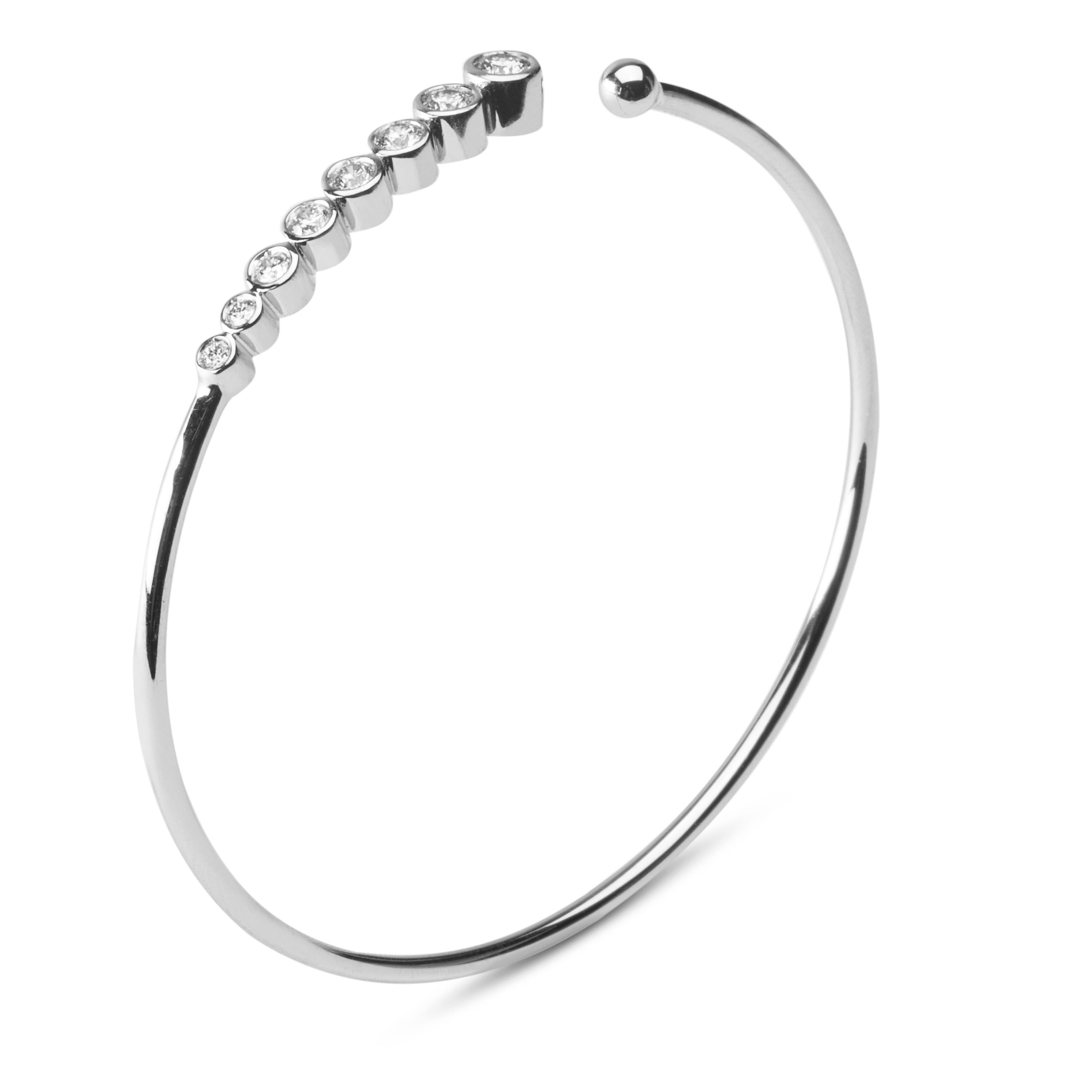 Jona design collection, hand crafted in Italy, 18 karat white gold bangle bracelet featuring 8 brilliant cut white diamonds, F color, VVS1 clarity, weighing 0.76 carats in total. 
Dimensions:
2 in. H x 2.33 in. W x 0.18 in. D
51 mm. H x 60 mm. W x 5