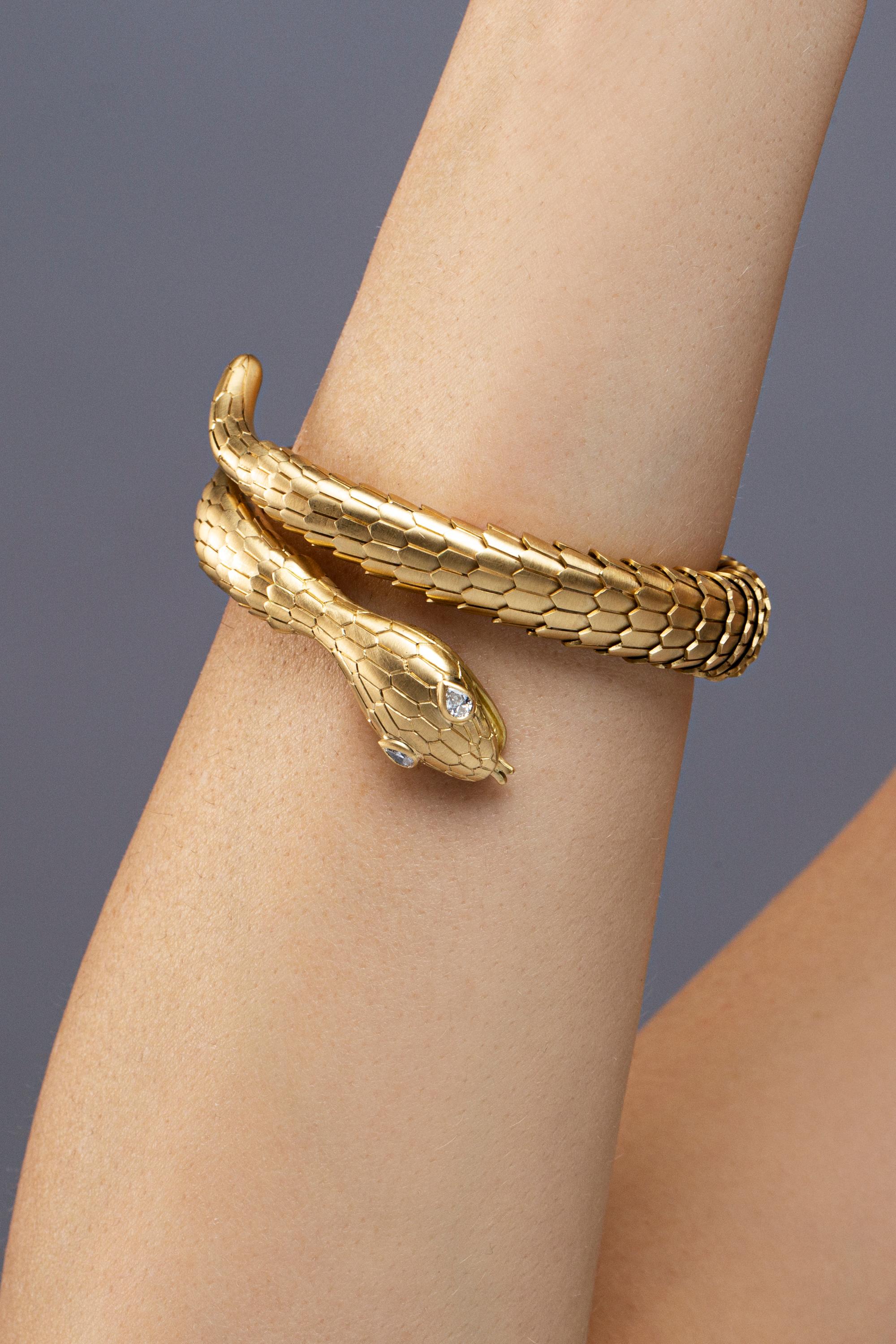 Jona design collection, hand crafted in Italy, 18 karat brushed yellow gold flexible coil snake bracelet. Two drop cut diamonds weighting 0.19 carats set on the head of the serpent. The body made of flexible scaled brushed gold links.
Dimensions: H