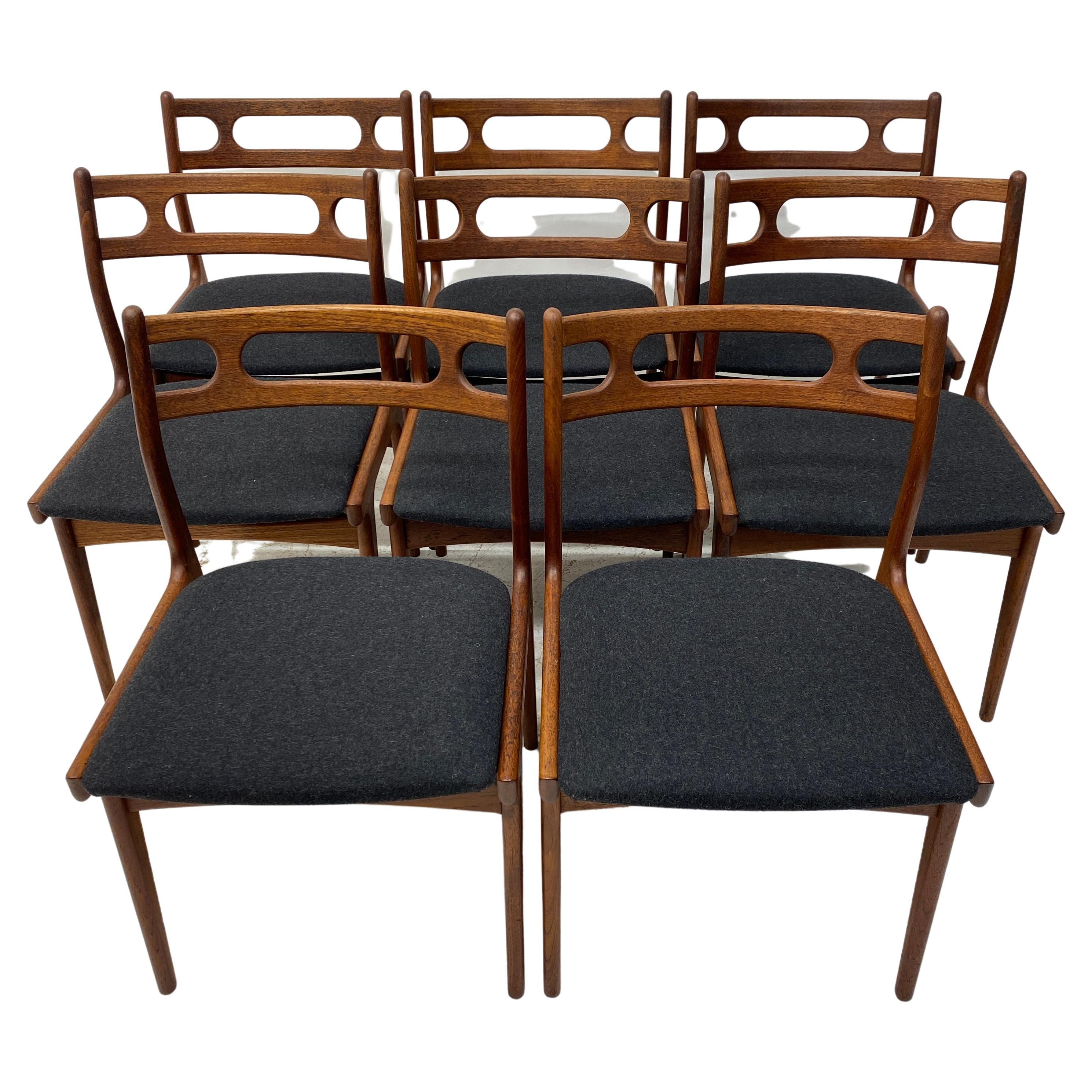 A truly superb set of eight Danish dining chairs designed by Johannes Anderson & manufactured by Uldum Mobelfabrik. They are midcentury circa 1960s dining chairs. Model 138. The dining chairs are constructed of solid teak with a very active grain.