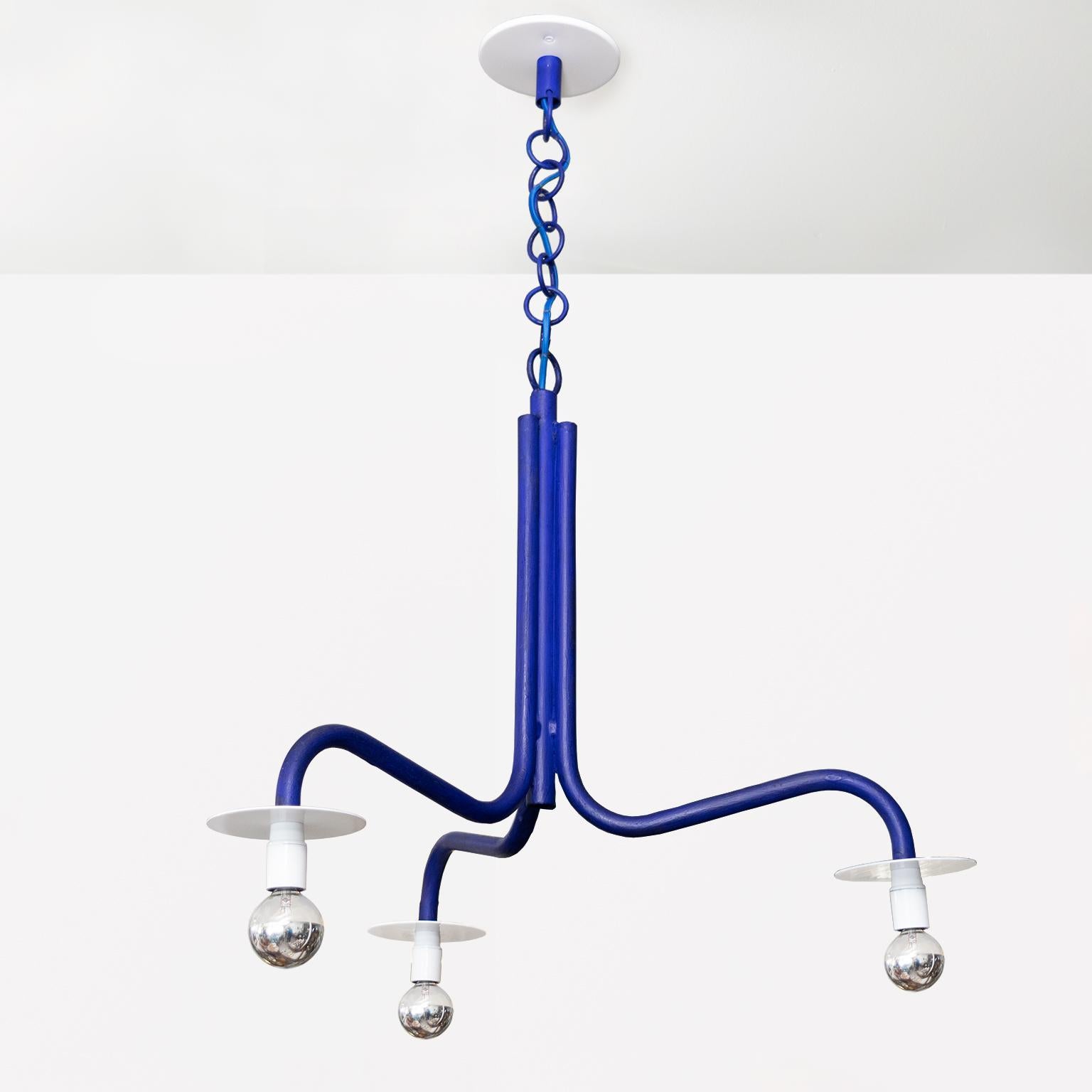 A, circa 1990 3-arm chandelier by Swedish designer Jonas Bohlin. This fixture was created exclusively for the Stockholm restaurant Rolfs Kök. 

This fixture is made from tubular iron finished with ultramarine paint, reflectors in white. A custom