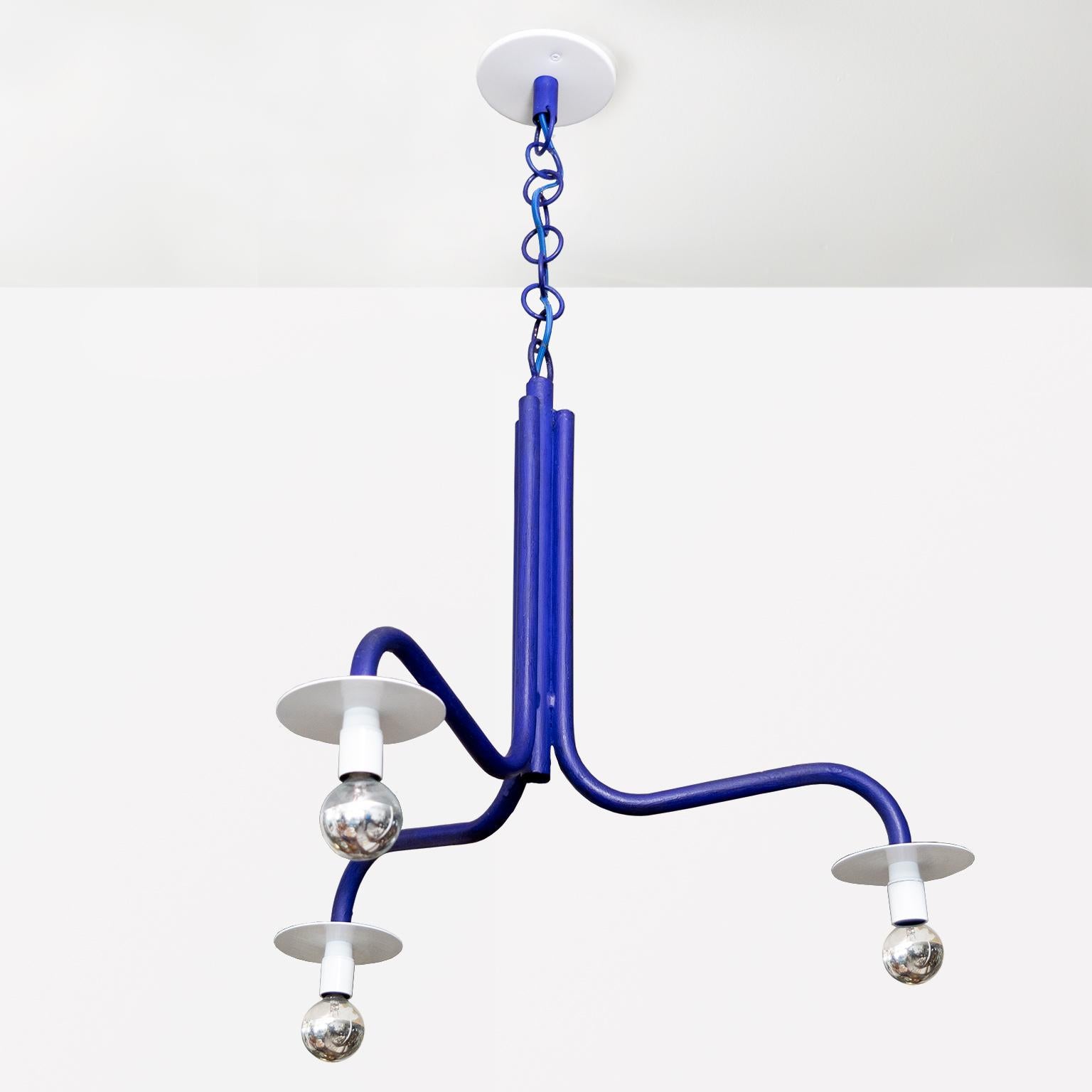 A circa 1990 3-arm chandelier by Swedish designer Jonas Bohlin. This fixture was created exclusively for the Stockholm restaurant Rolfs Kök. 

This fixture is made from tubular iron finished with ultramarine paint, reflectors in white. A custom