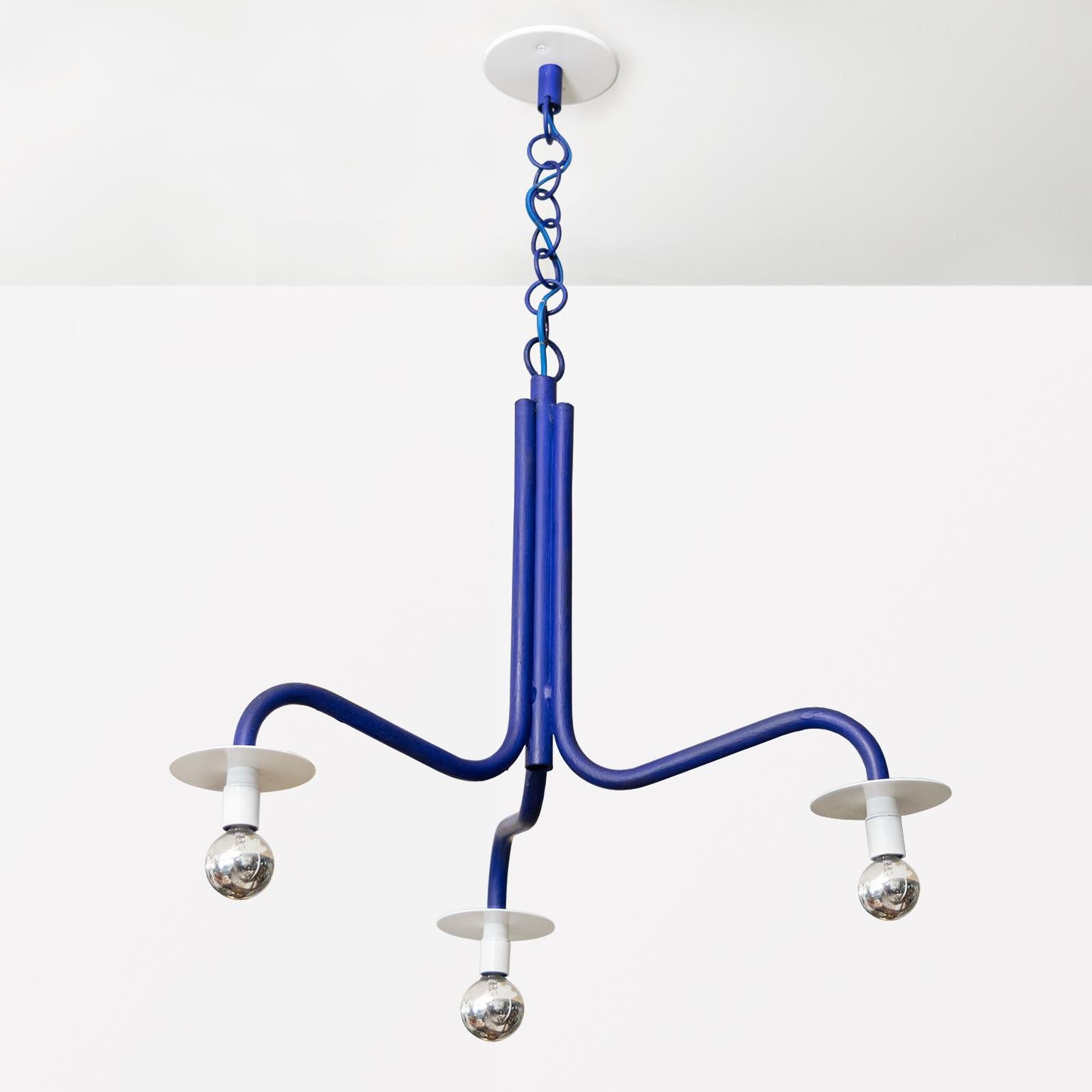 A, circa 1990 3-arm chandelier by Swedish designer Jonas Bohlin. This fixture was created exclusively for the Stockholm restaurant Rolfs Kök. 

This fixture is made from tubular iron finished with ultramarine paint, reflectors in white. A custom