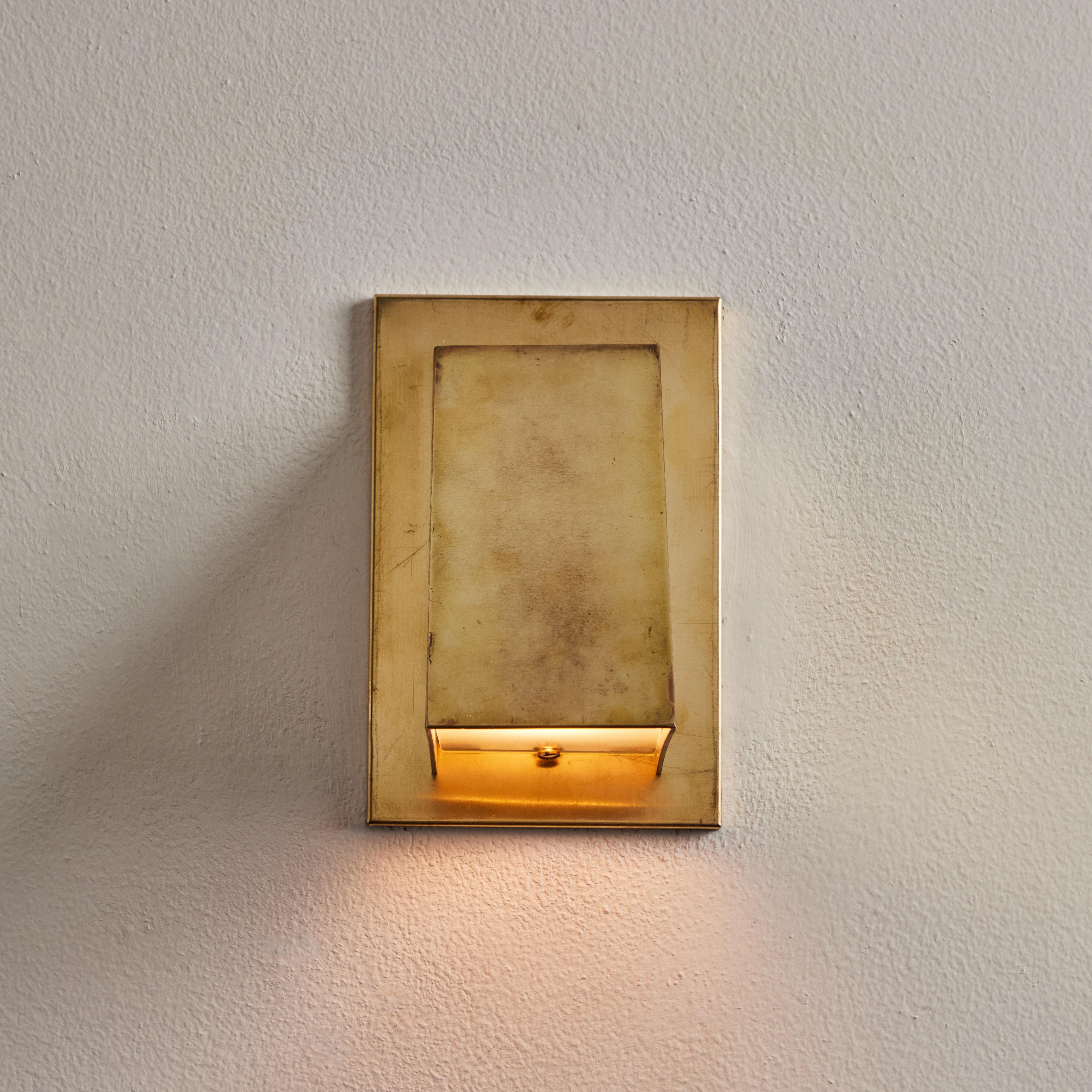 Jonas Bohlin 'Oxid' Raw Brass Outdoor Wall Light for Örsjö. Executed in raw unlacquered and unpolished brass with an opaline glass diffuser. An incredibly refined and clean geometric design that is quintessentially Scandinavian. For indoor or