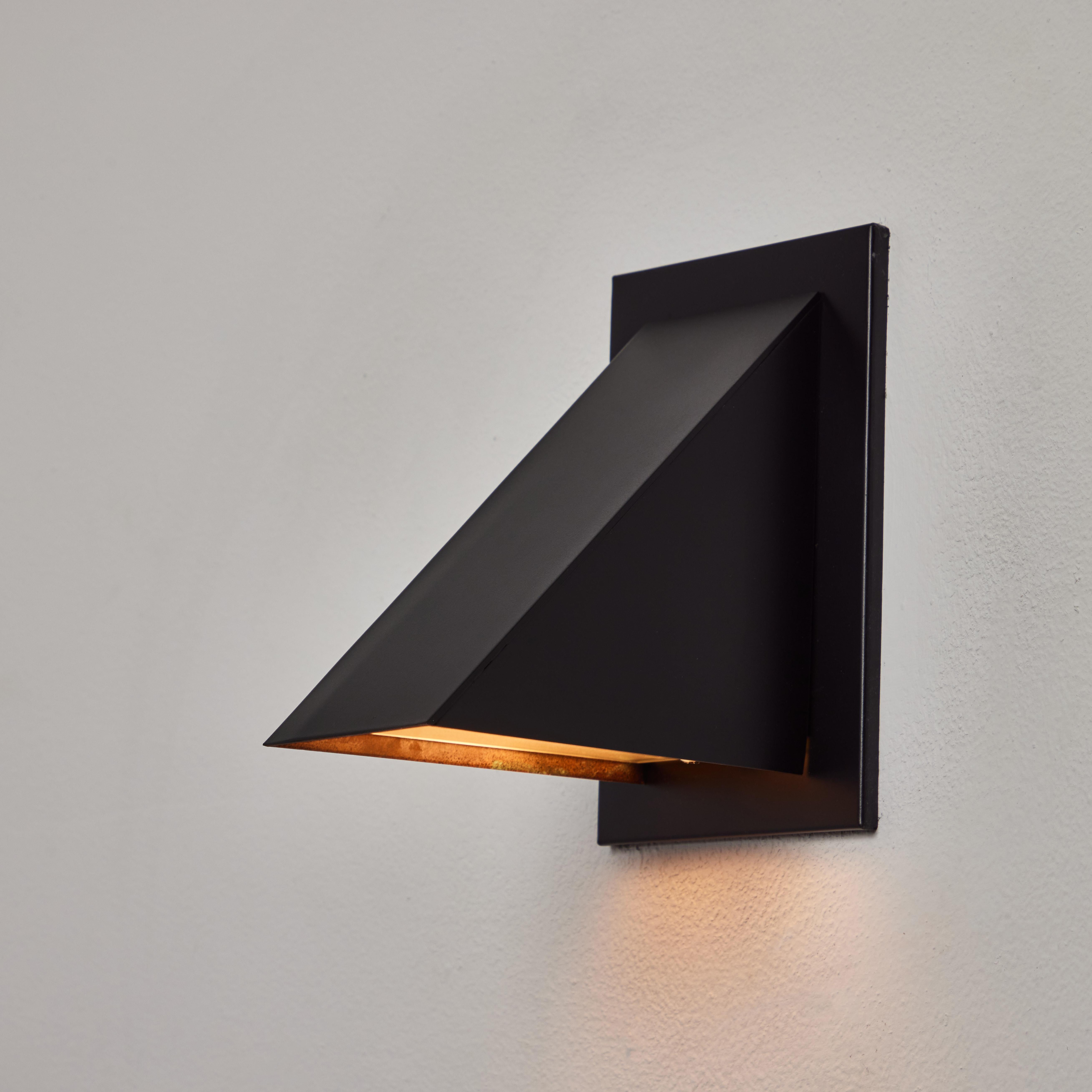 Jonas Bohlin 'Oxid' Wall Light for Örsjö in Black. Executed in black painted metal with an opaline glass diffuser. An incredibly refined and clean geometric design that is quintessentially Scandinavian. For indoor or outdoor use.

Price is per item.