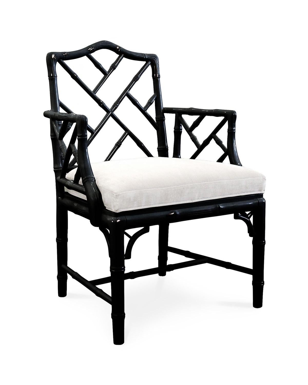 Listed is a fabulous, pair of black lacquered faux bamboo Chinese Chippendale armchairs with white linen upholstered seats, by Jonathan Adler. The chairs have been a staple in Adler's design production for years, and has recently been discontinued