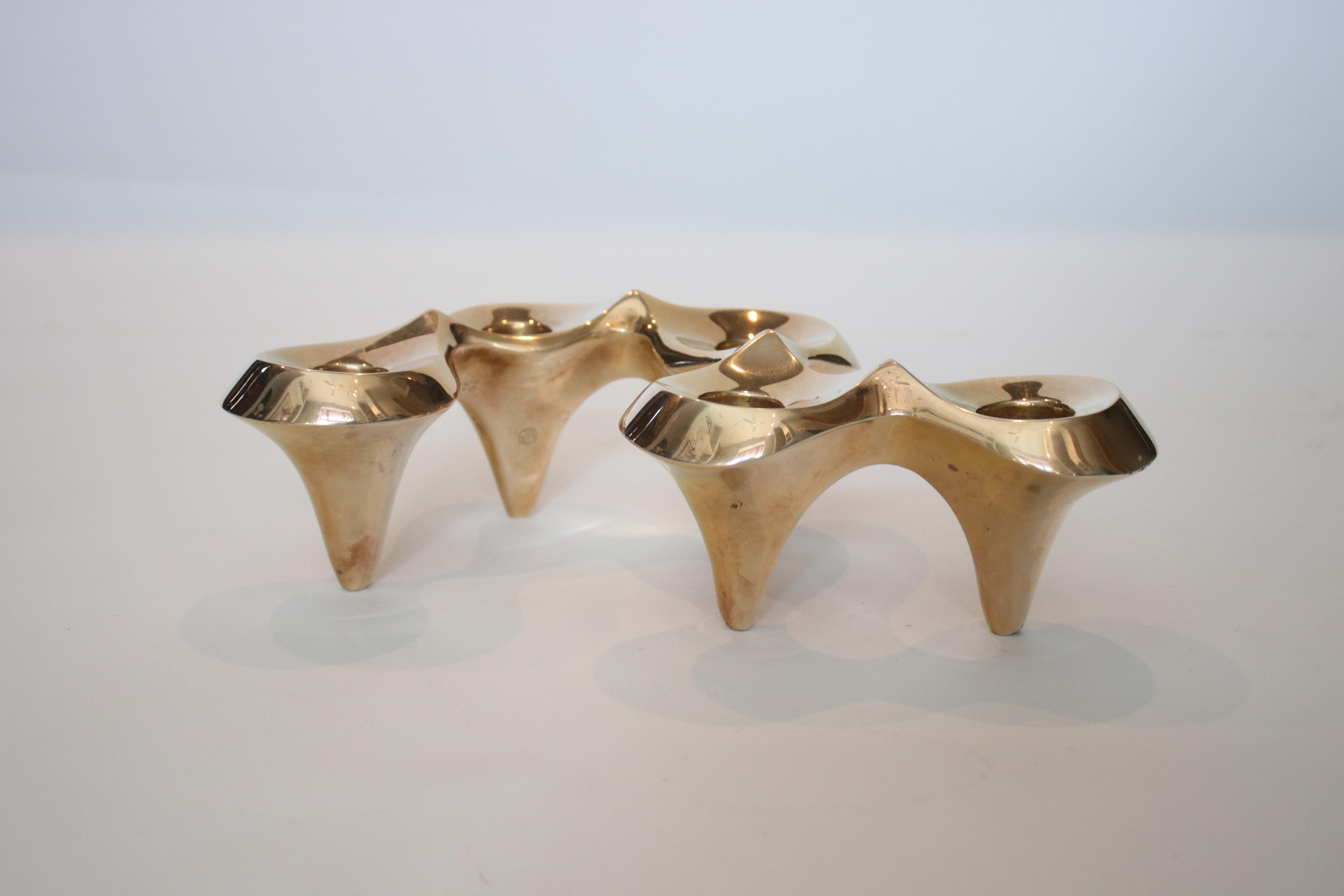 Retired edition of Jonathan Adler's brass undulating candelabra sold at Neiman Marcus. Each piece was hand sculpted in his Soho studio and then sand cast in brass and hand polished. Very Good Condition.