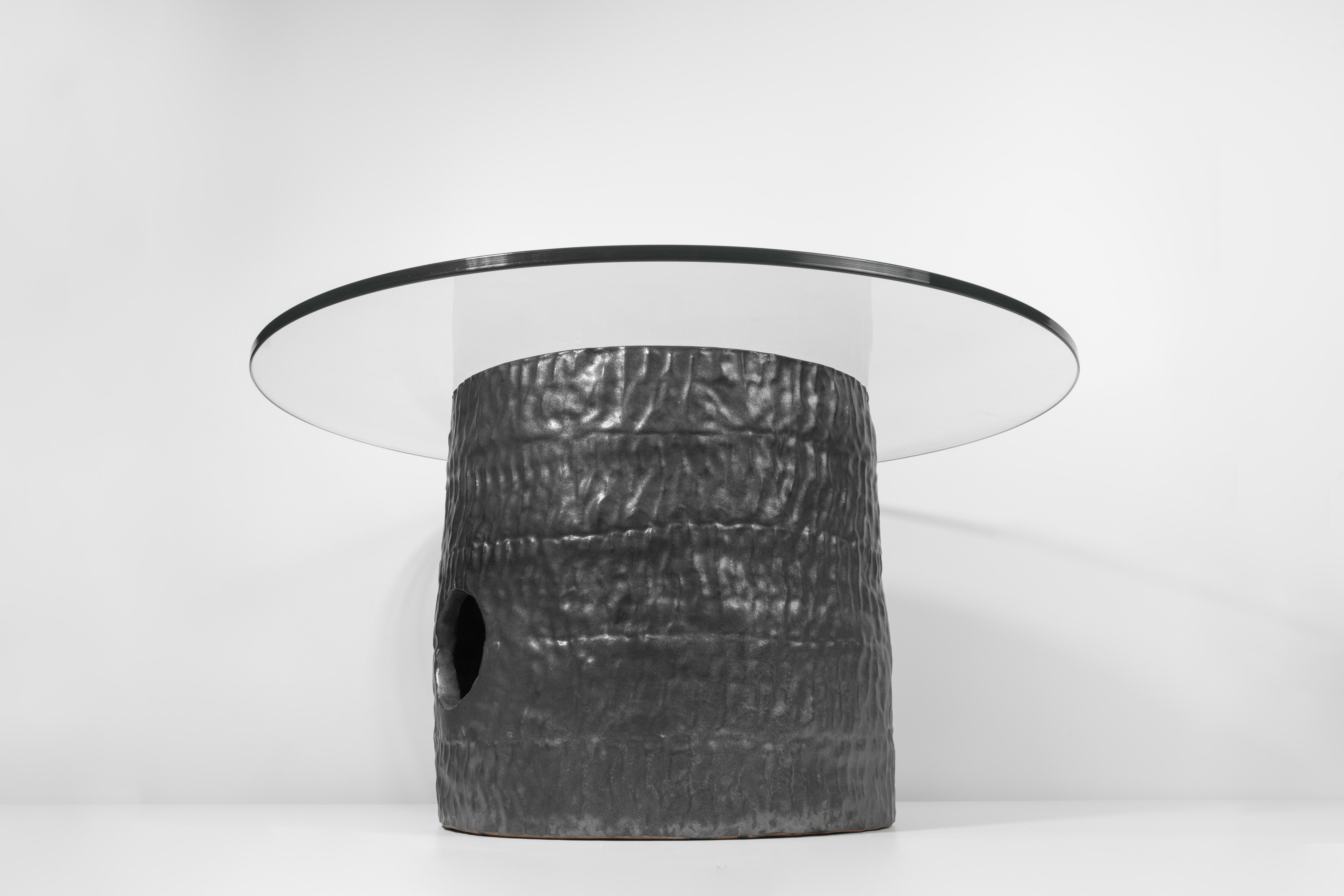 Coil-built ceramic and glass table with black coppered glaze. Marked with an engraved bronze label to underside: Jonathan Nesci w/ Robert Pulley 18/17. 

Designed by Jonathan Nesci and made in Columbus, Indiana by local ceramist Robert Pulley for