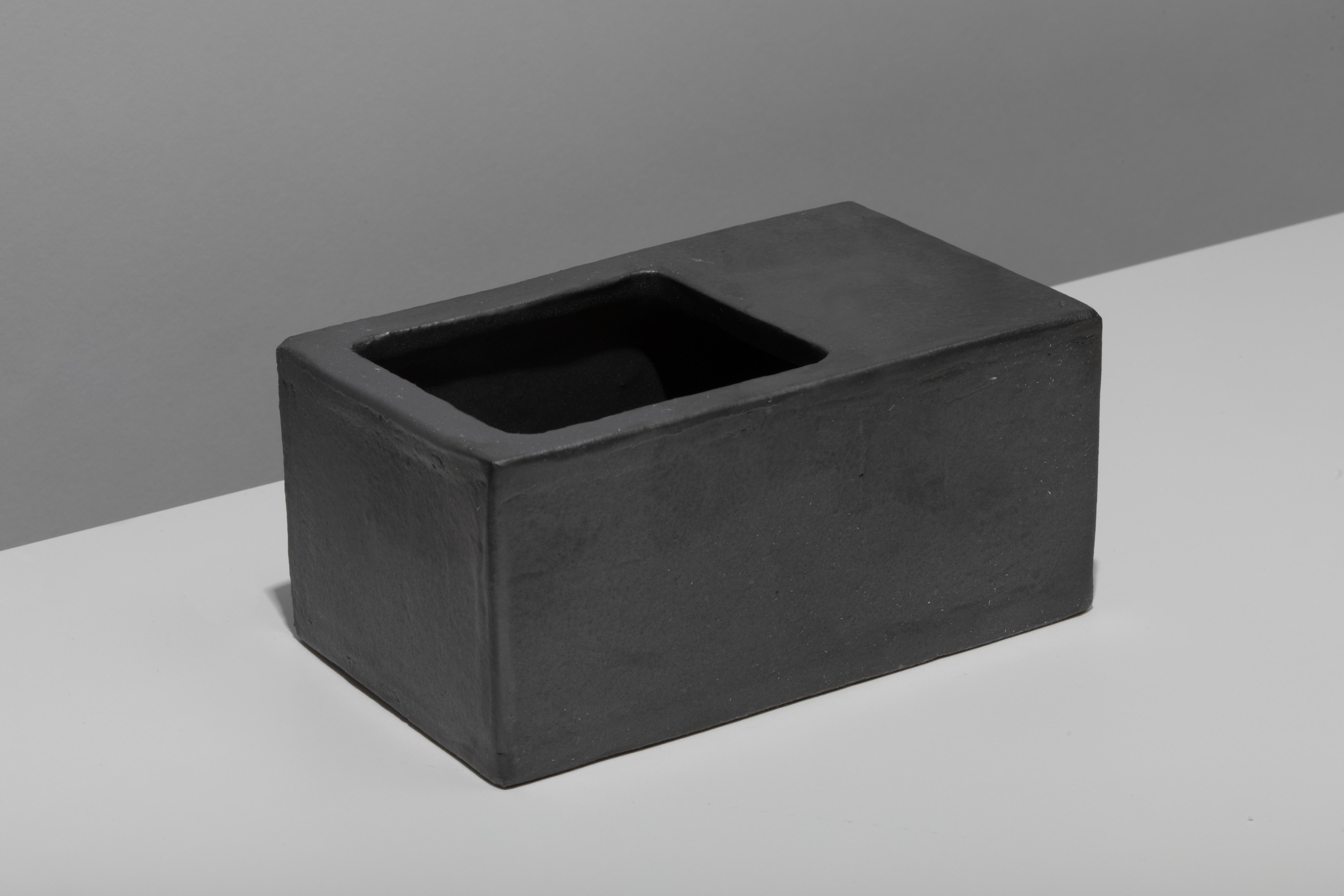 Slab-built ceramic vessel with black coppered glaze. Marked with an engraved bronze label to underside: Jonathan Nesci w/ Robert Pulley 18/03. 

Designed by Jonathan Nesci and made in Columbus, Indiana by local ceramist Robert Pulley for inaugural