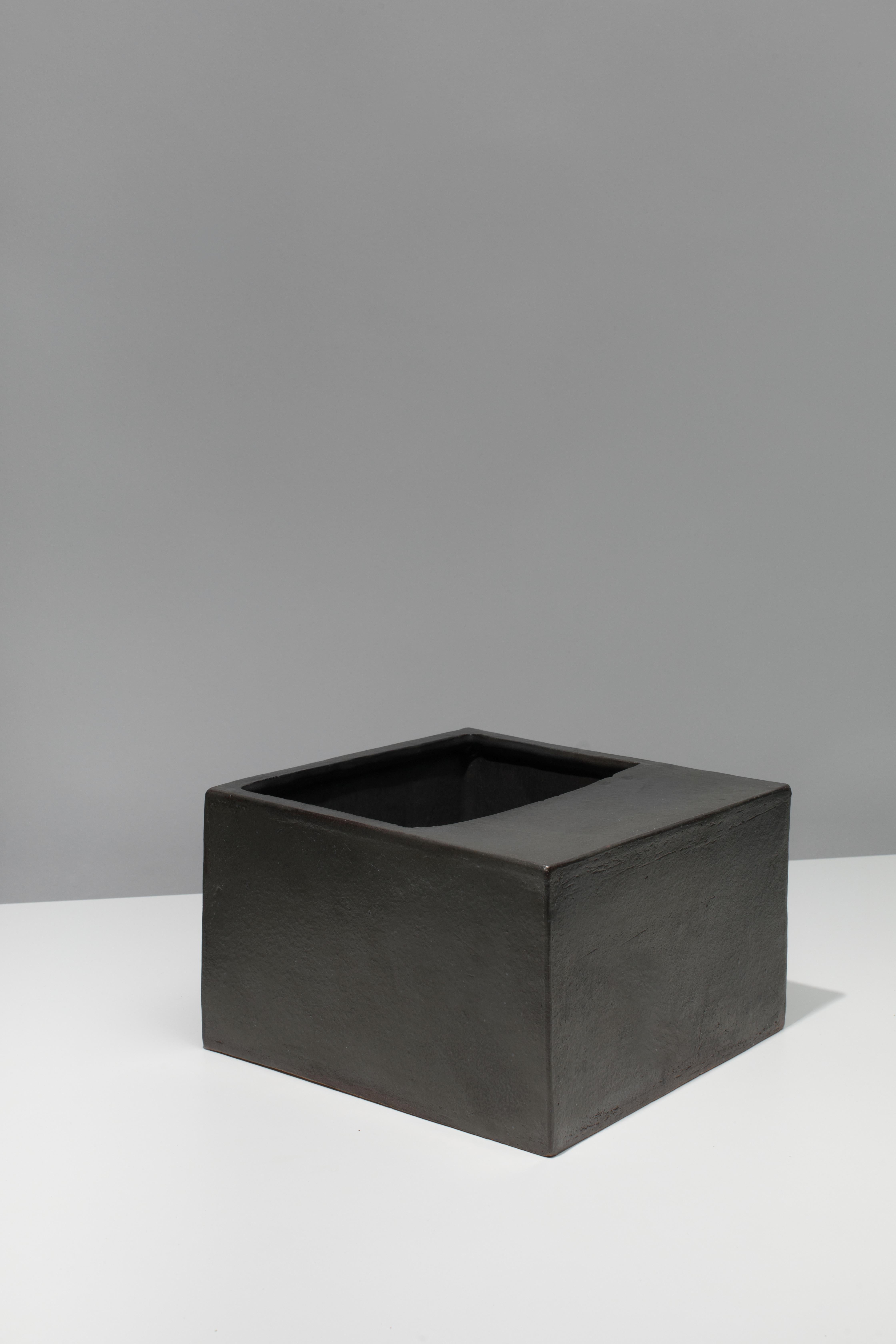 Wheel-thrown and slab-built ceramic vessel with black coppered glaze. Marked with an engraved bronze label to underside: Jonathan Nesci w/ Robert Pulley 18/09. 

Designed by Jonathan Nesci and made in Columbus, Indiana by local ceramist Robert