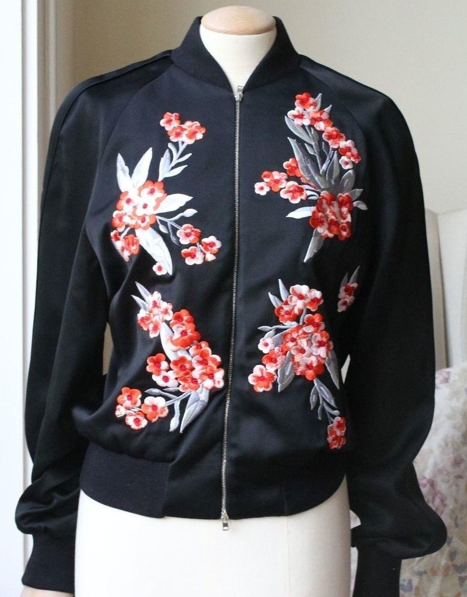 Cut from fluid black satin, Jonathan Saunders' 'Cecily' bomber is intricately embroidered with a contrasting poppy pattern and is designed for relaxed, slouchy fit. Black satin. Red and pastel-pink floral embroidery, slit pockets, pastel-pink