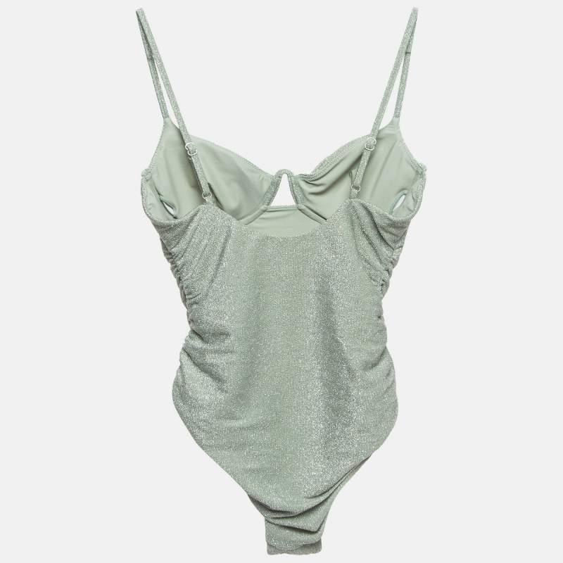 The Jonathan Simkhai swimsuit offers a luxurious beachwear option. Featuring a shimmery lurex knit fabric this swimsuit is beautifully ruched for a flattering fit. The sage green hue complements the textured design providing a chic and modern look.
