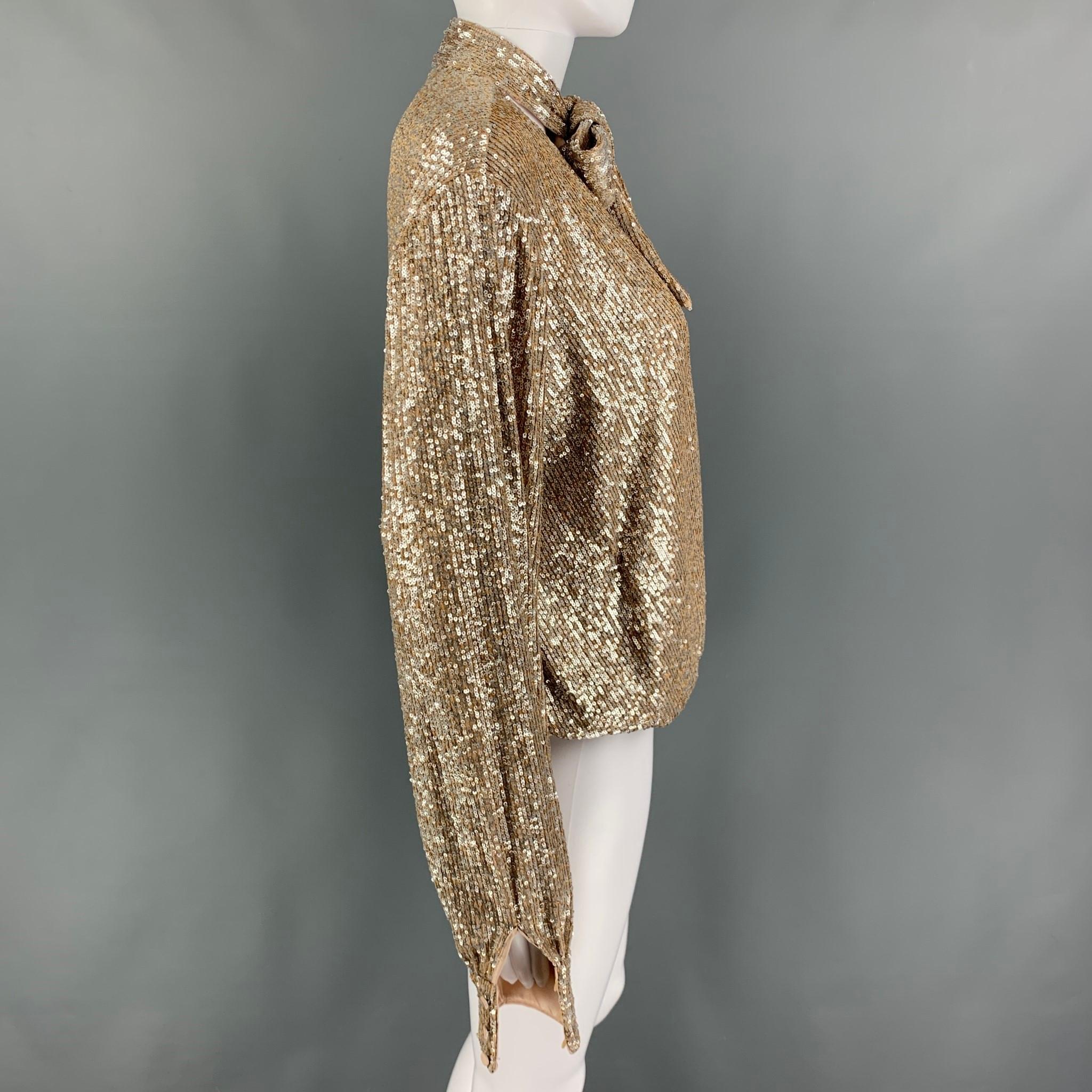 JONATHAN SIMKHAI bodysuit comes in a champagne sequined polyester featuring a open front, long sleeves, front bow design, and a hook & loop closure. 

New with tags. 
Marked: L

Measurements:
 
Shoulder: 17 in.
Bust: 40 in.
Sleeve: 28 in.
Length: 22