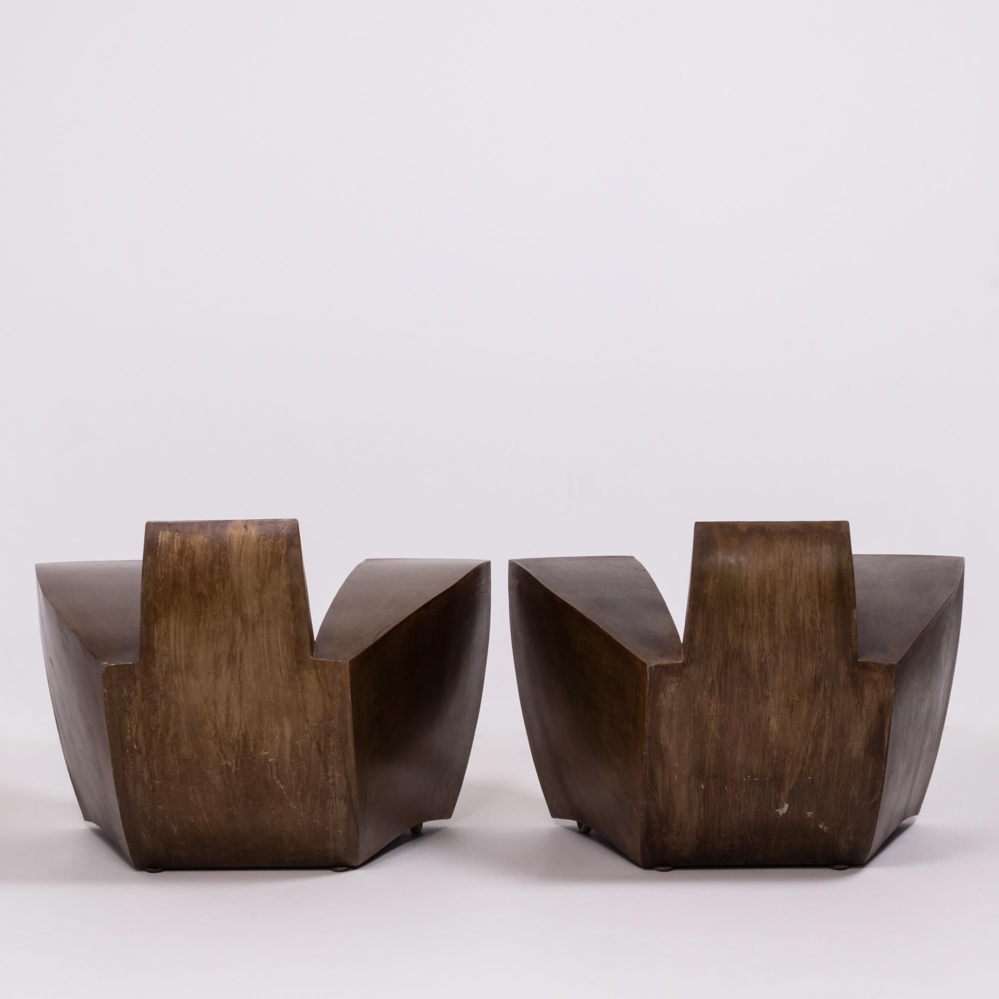 Designed by Jonathan Singleton and made in his Barcelona studio, this pair of easy number one armchairs are bold and unique.

Constructed in aged steel, the chairs have a striking silhouette, with wide arms and a curved back. The chairs have two