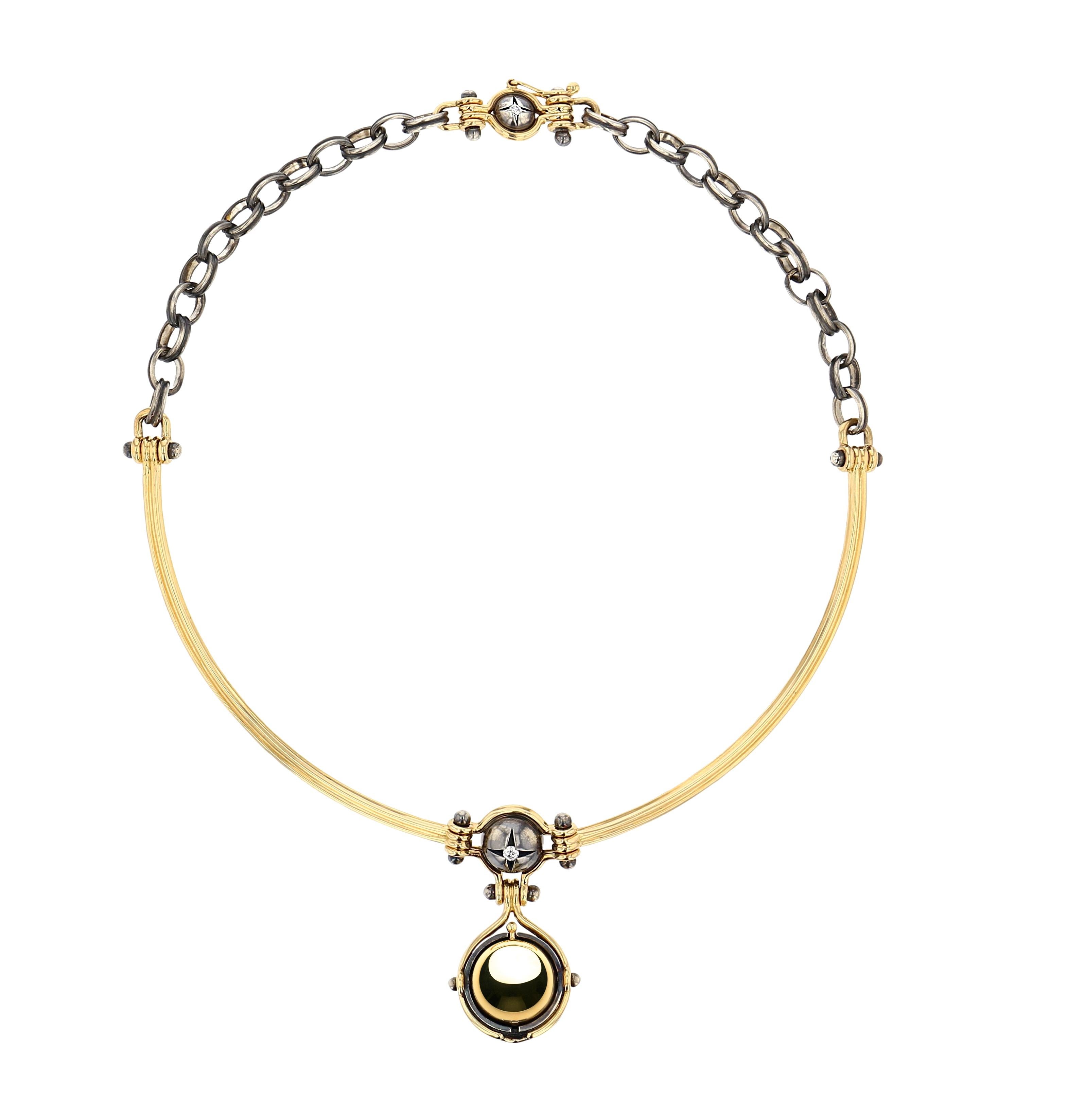 Yellow gold and distressed silver necklace. Rotating sphere revealing an akoya pearl, set with a diamond and encircled by a white gold ring set with a diamond.  

Yellow gold wire and distressed silver chain.

Details:
Akoya Pearl 
Diamonds
18k