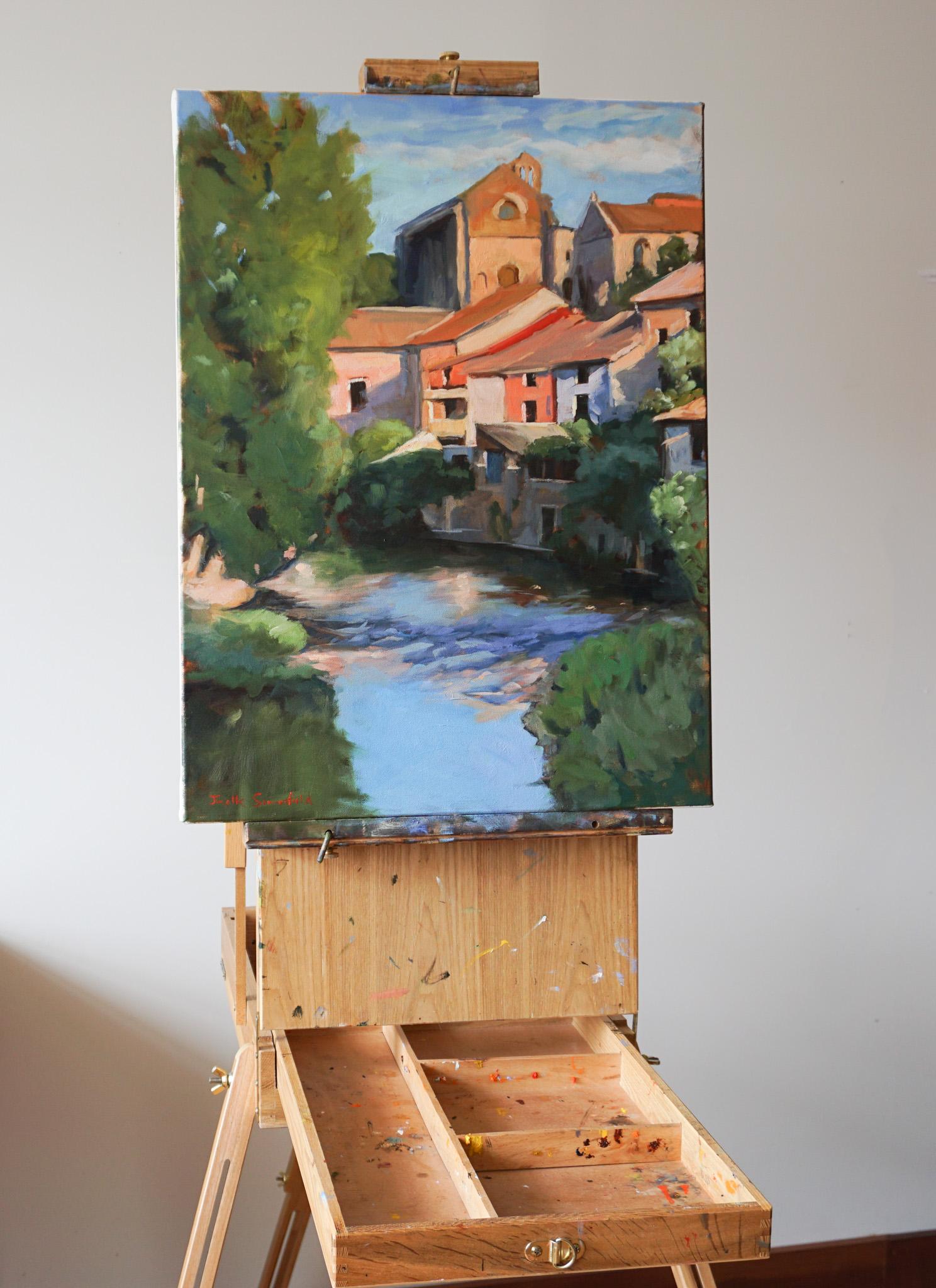 <p>Artist Comments<br>The painting offers a glimpse of the houses surrounding a river in Estella, Spain, a charming town along the Camino de Santiago. The sun casts a warm glow onto the picturesque location, tossing shadows onto apricot-colored