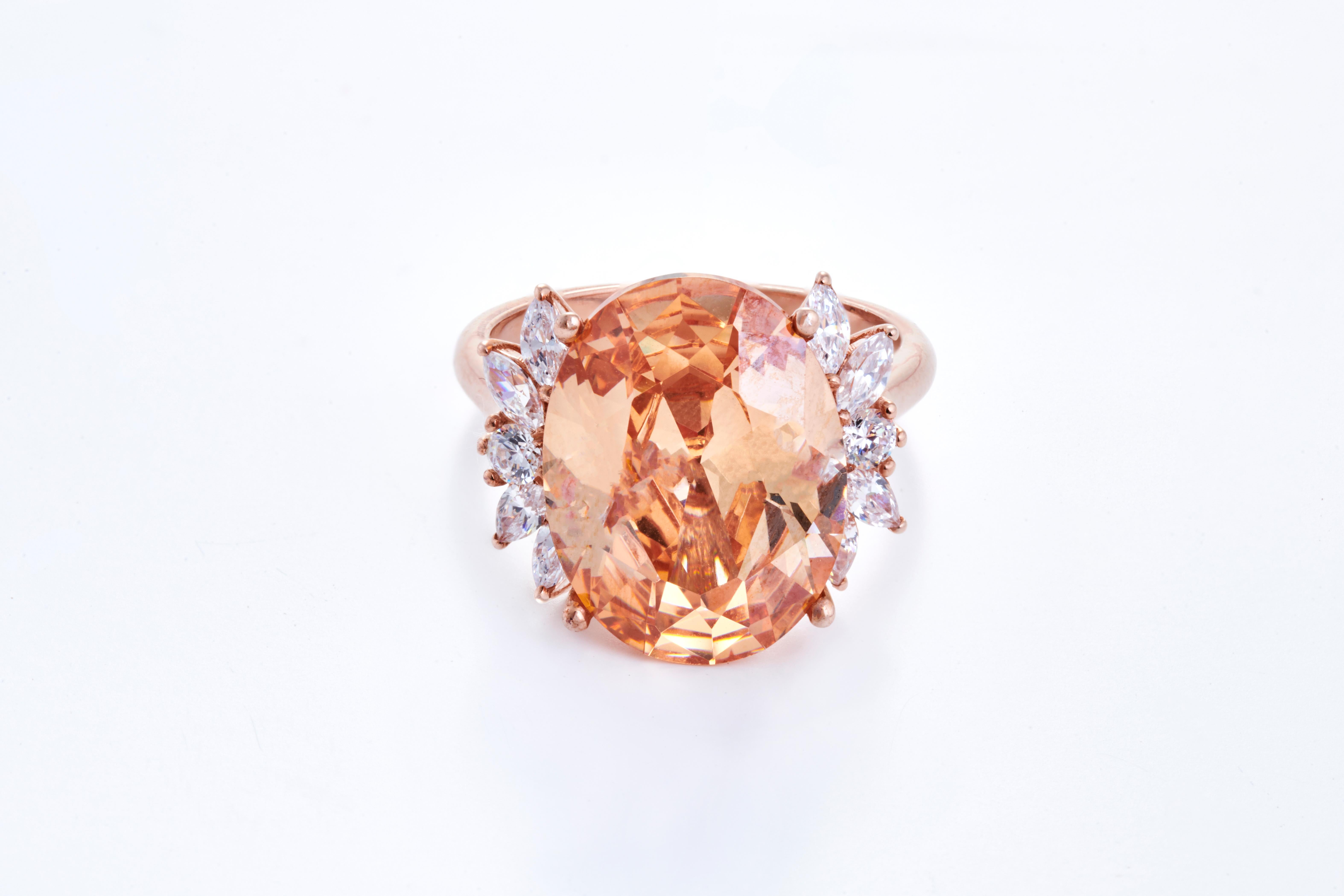 Set in 4.40 grams of 18K Rose Gold with 2 round cut diamonds on and sides and 8 Marquise cut diamond around them in VS/G quality and colour weighing 0.35 carats. 
The Morganite is the most admired gem amongst all the beryl group members, due to its