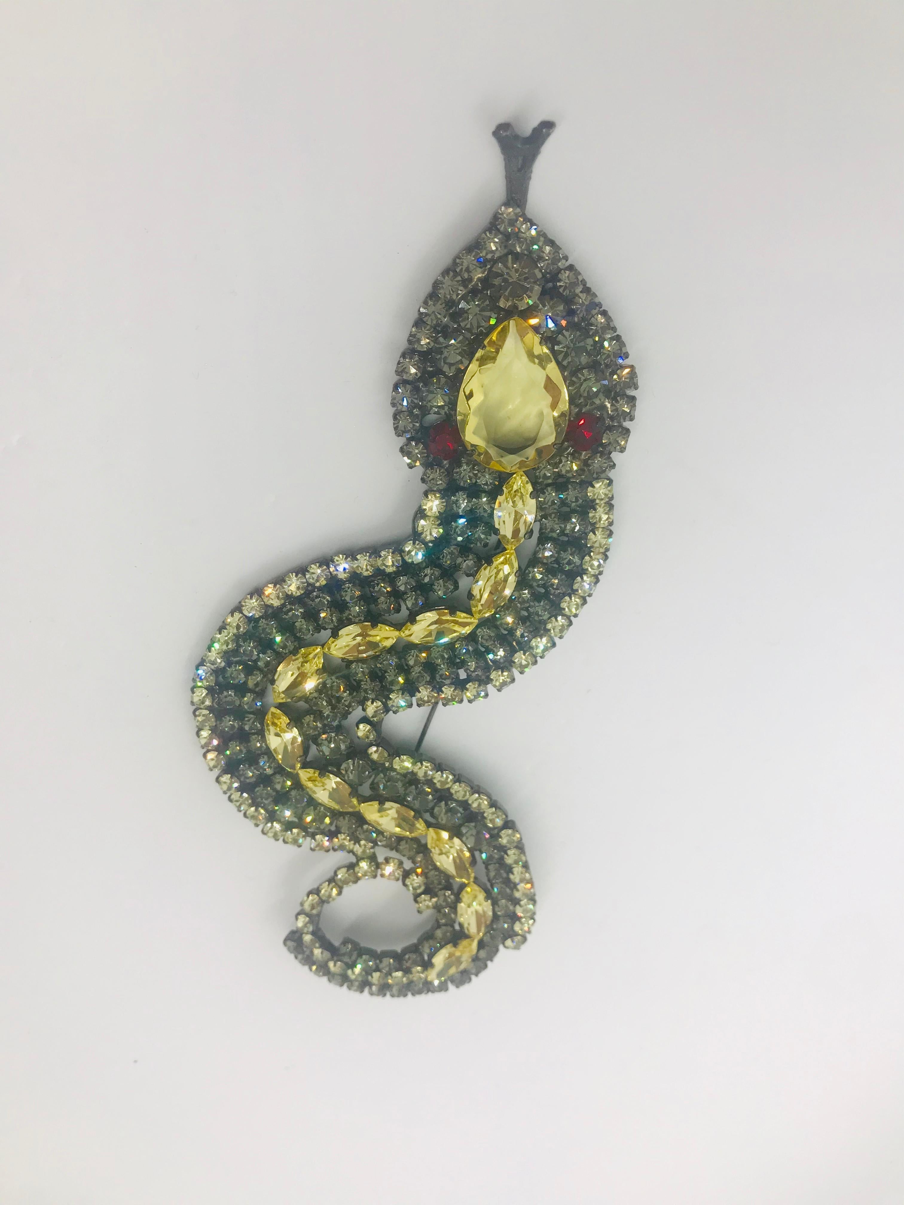 Historically snakes and serpents represent immortality and healing powers.  Our jonquil Czech and black diamond Austrian crystal snake brooch is reminiscent of Victorian snake jewelry.  This snake brooch features a large unfoiled Czech jonquil pear