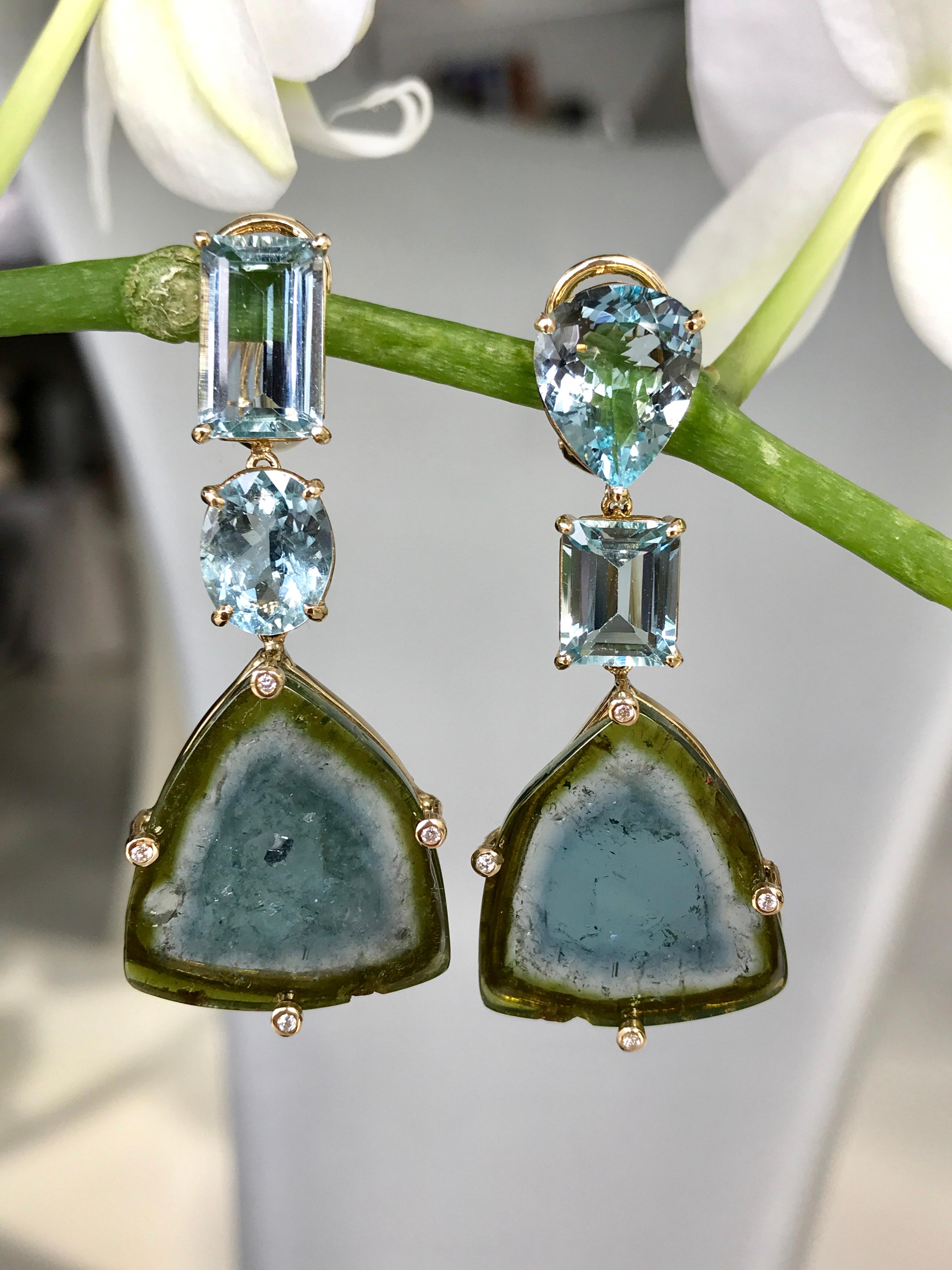 Faceted aquamarine and bicolor tourmaline slice drop dangle earrings accented with diamonds, handcrafted in 18 karat yellow gold. 1.92 inches or 49 mm length.

These one-of-a-kind earrings feature unusual and rare bicolor blue and green 
