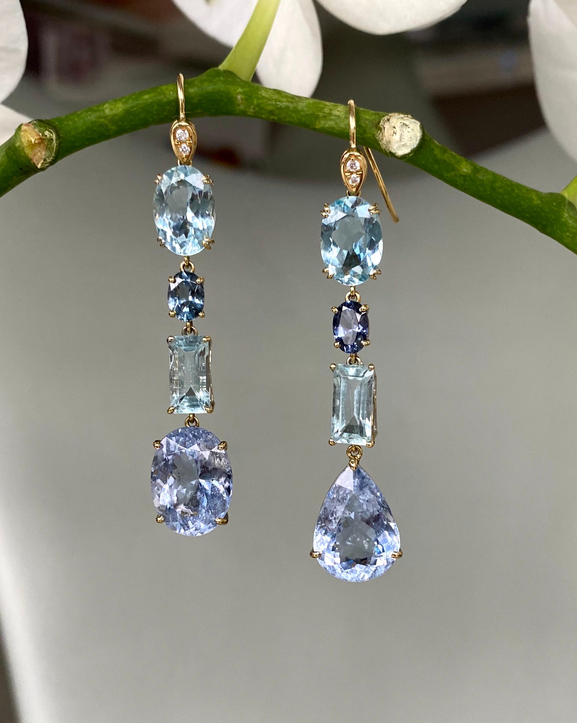 One-of-a-kind dangle earrings of faceted multi-shaped aquamarines, blue beryls and diamonds, handcrafted in 18 karat yellow gold.

These sparkling earrings in gorgeous shades of blue are purposely 