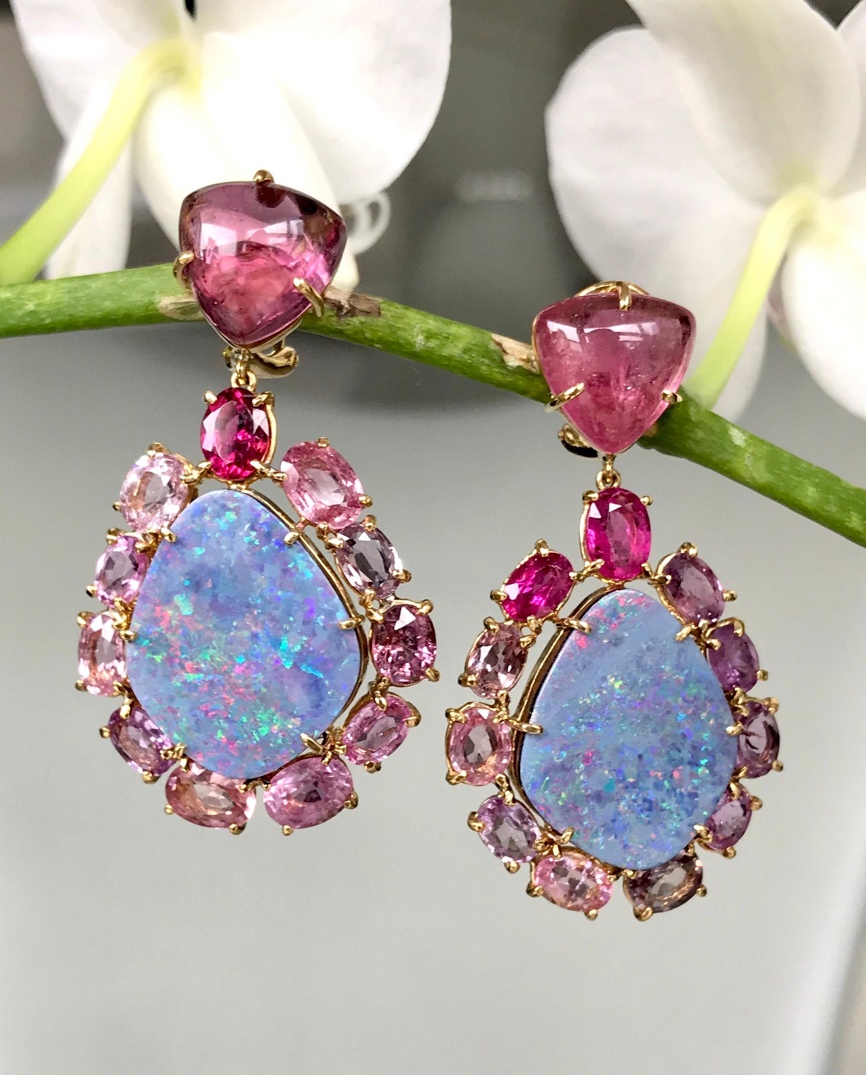 Australian boulder opals encircled by sparkling, faceted pink sapphires with a luminous cabochon pink tourmaline on top, handcrafted in 18 karat yellow gold. 

Iridescent Australian boulder opals are encircled by a symphony of rich, multi-hued pink