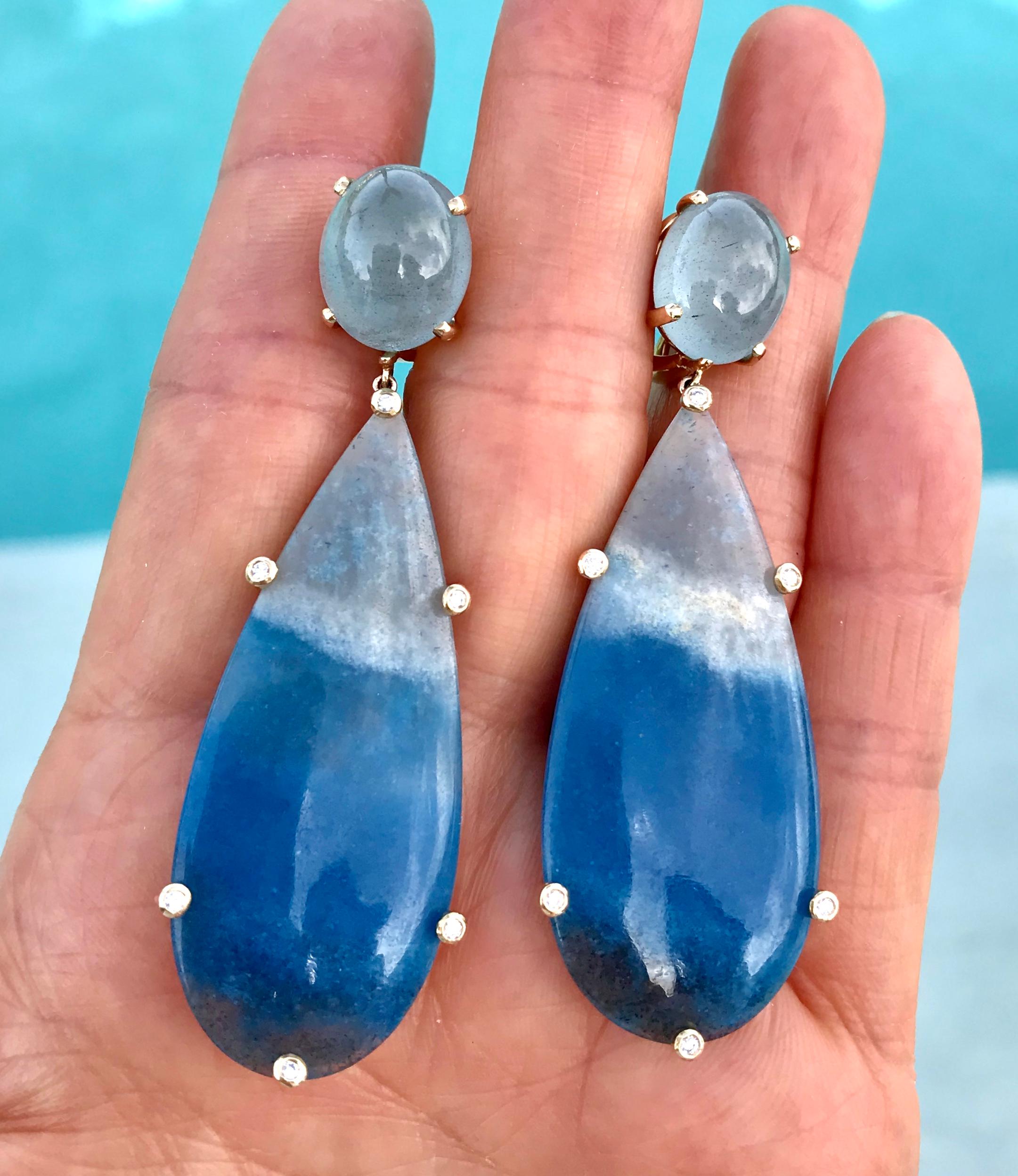 One-of-a-kind cabochon aquamarine, quartz and diamond dangle earrings, handcrafted in 18 karat yellow gold.

These vibrant earrings, in pretty shades of blue and grey, evoke the beautiful seas and waves. They are a major statement piece for your