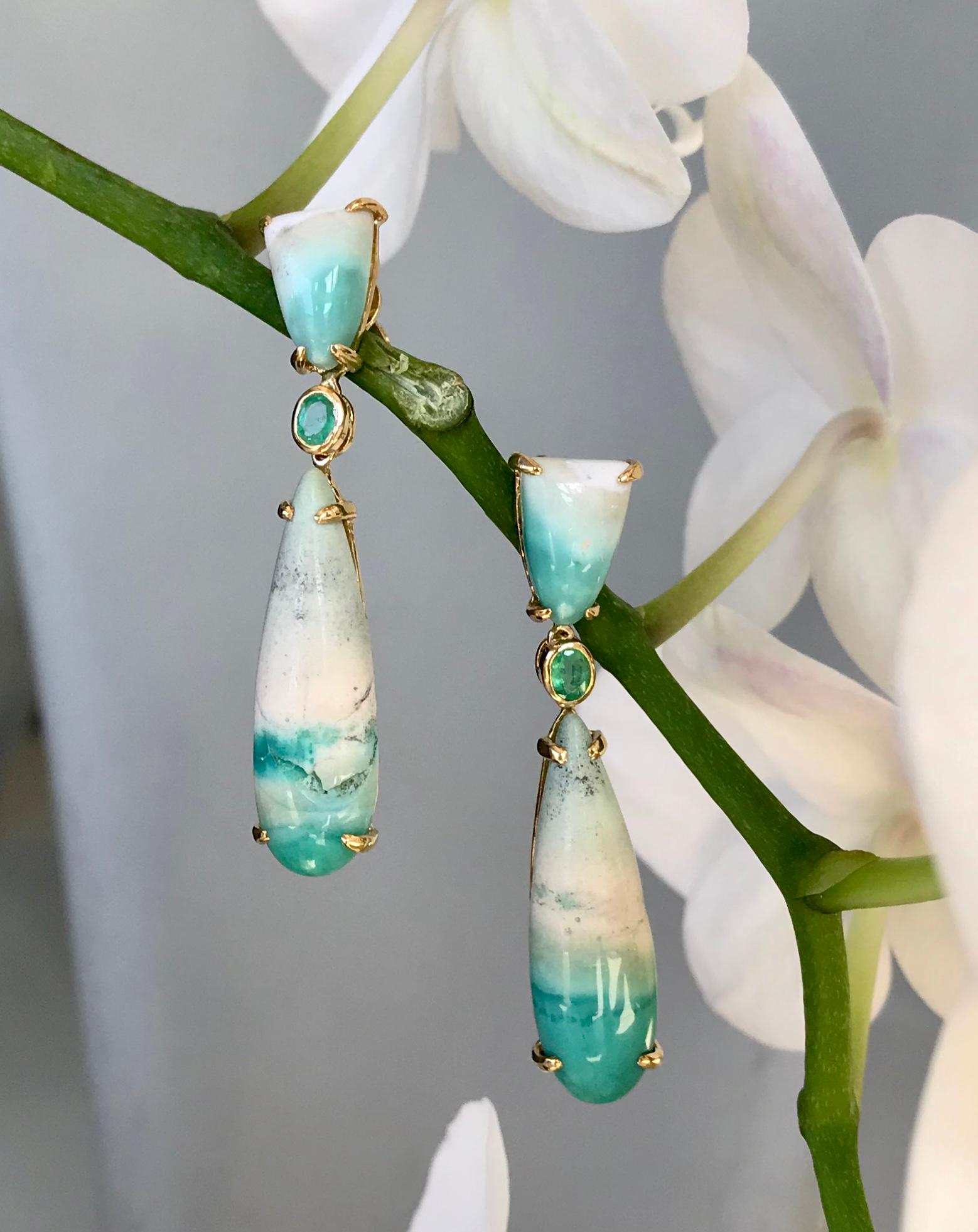These Joon Han one-of-a-kind emerald and opalized petrified wood drop dangle earrings are a refreshing color palette for the summer. The natural scenes etched on the opalized wood evoke sandy beaches and crashing blue green ocean waves. Light and
