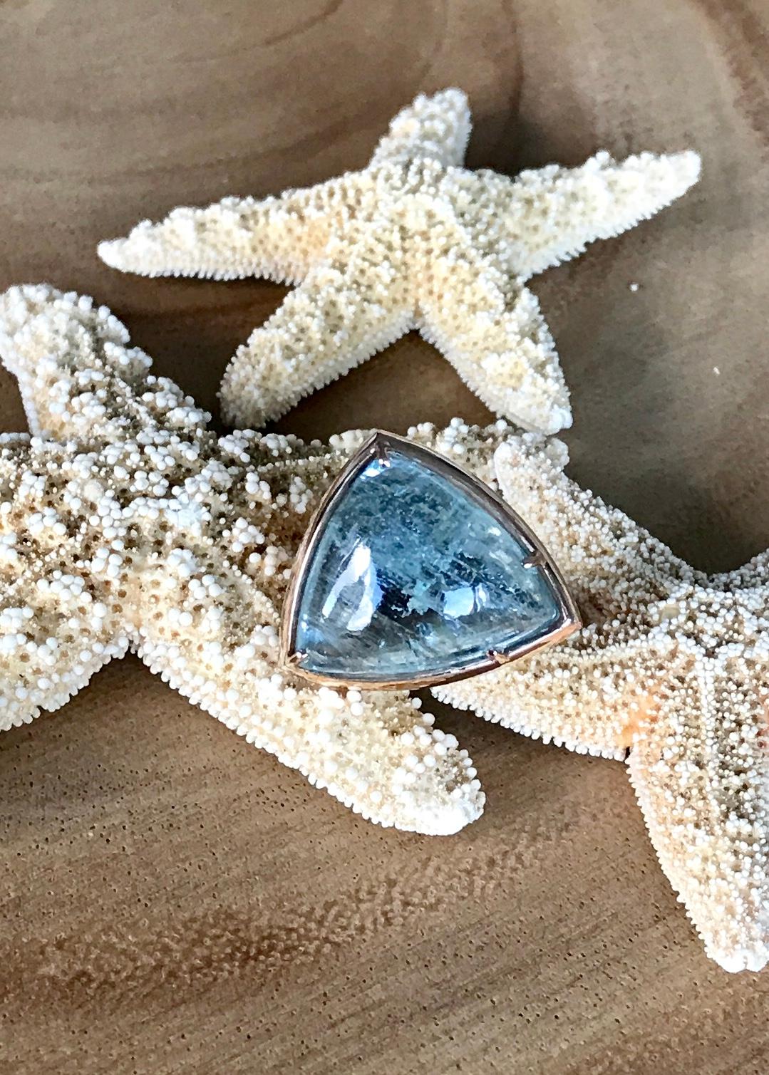 A fancy shaped cabochon aquamarine cocktail ring, handcrafted in 18 karat rose gold. US size 6.25.

Simply pretty best describes this luminescent fancy shaped aquamarine cocktail ring...a beautiful statement piece perfect for any occasion. The