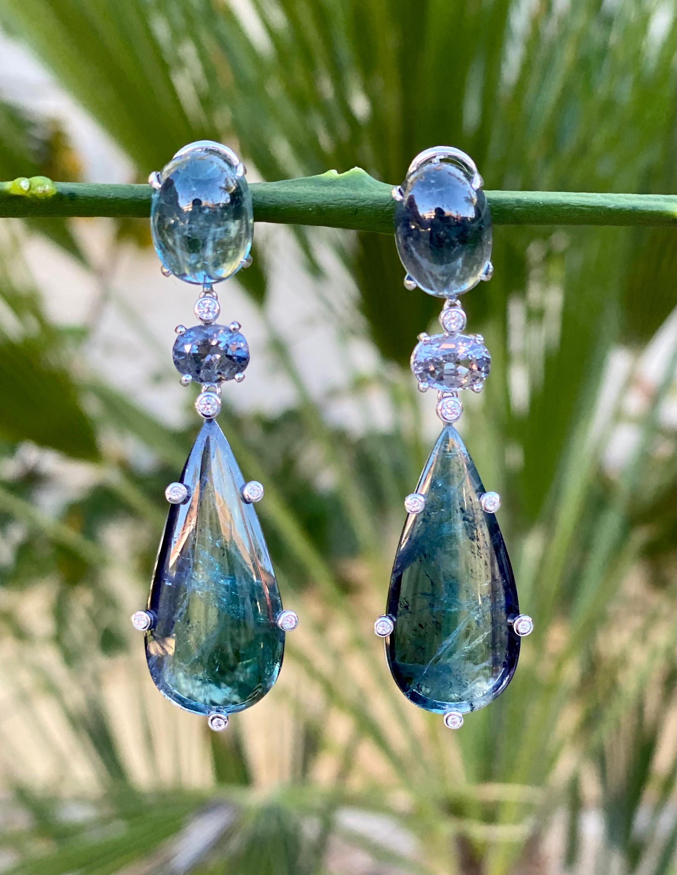 One-of-a-kind dangle earrings of indicolite and bicolor tourmalines, spinels and diamonds, handcrafted in 18 karat white gold.

These are a gorgeous pair of earrings of rare indicolite and bicolor tourmalines, with beautifully colored spinels and