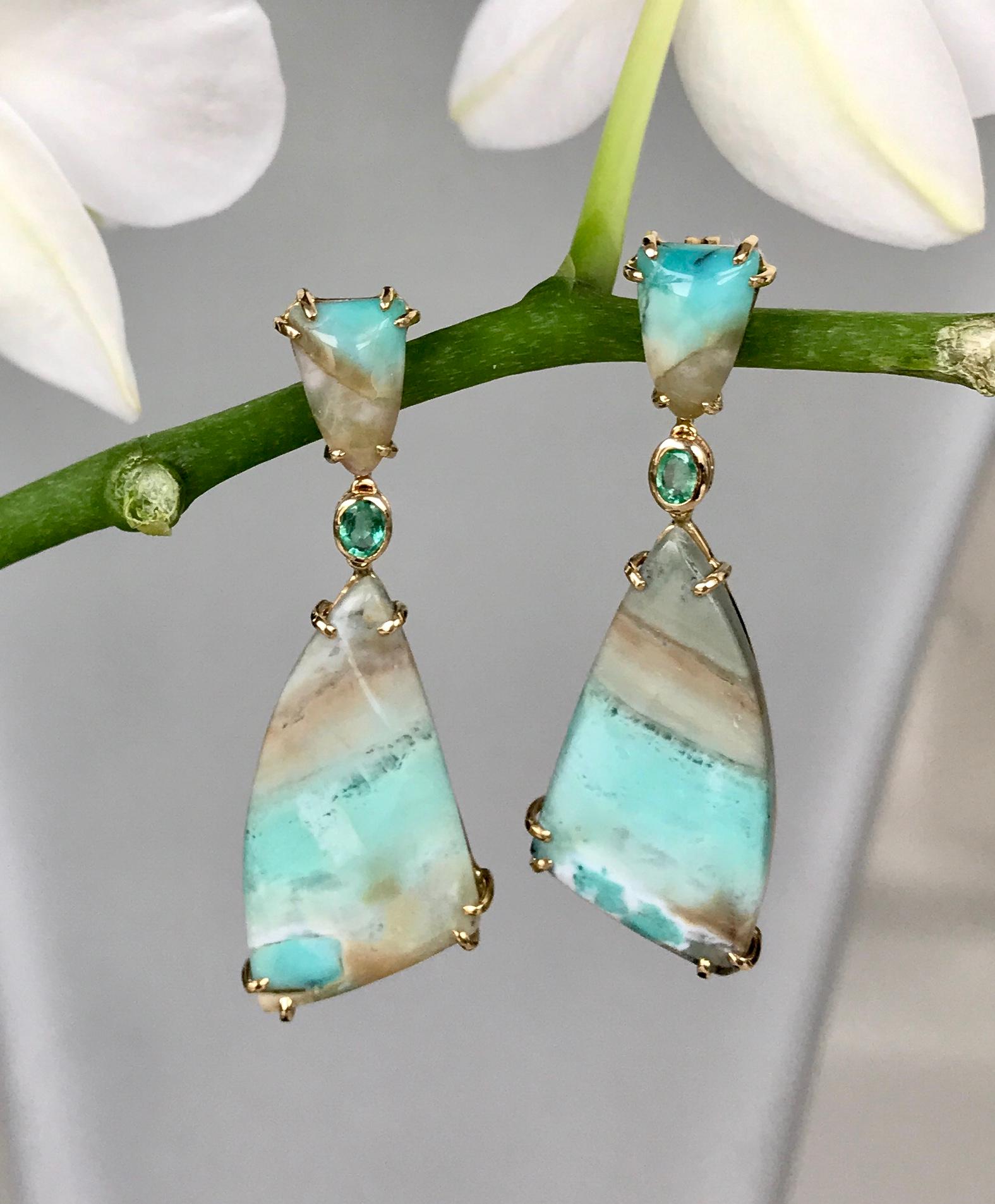 Joon Han one-of-a-kind fancy cut sail-shaped Indonesian opalized petrified wood and emerald drop dangle earrings are like an abstract brushstroke painting. Its dreamy hues evoke nature with its lush bluish greens and beiges bringing to mind the