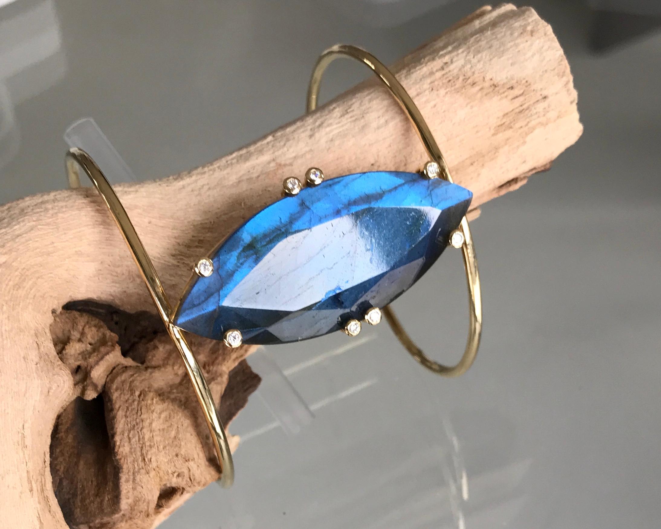 One-of-a-kind fancy marquise shaped Madagascar labradorite and diamond cuff bracelet. Handcrafted in 18 karat yellow gold. 

The amazing blue flash labradorite is the centerpiece of this stunning cuff bracelet. This magical gemstone radiates varying