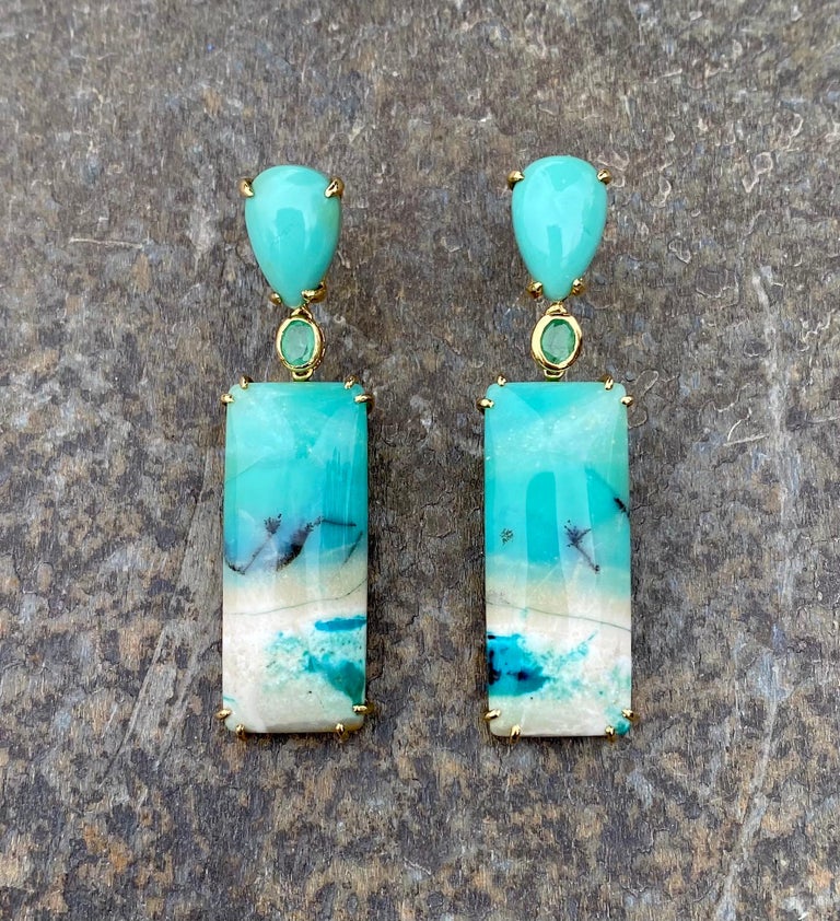 Opalized petrified wood and emerald earrings, handcrafted in 18 karat yellow gold.

These beautiful one-of-a-kind earrings in beautiful shades of green evoke underwater beach scenes of the undulating waters and the sandy bottom of the sea. It's like