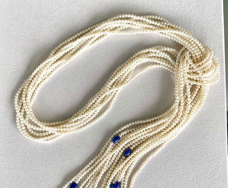 A seven strand necklace of round white seed pearls and blue sapphire beads.

This beautifully versatile one-of-a-kind pearl necklace can be worn in so many ways, depending on your mood and the look you’d like to present. Comprised of seven strands