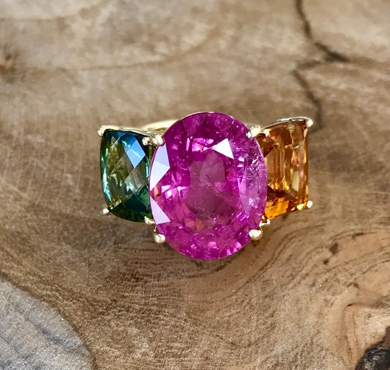 One-of-a-kind three-stone cocktail ring of pink tourmaline, citrine and green tourmaline, handcrafted in 18 karat yellow gold.

This classic three-stone cocktail ring is vibrant in its combination of gemstones and colors, with the focus on the