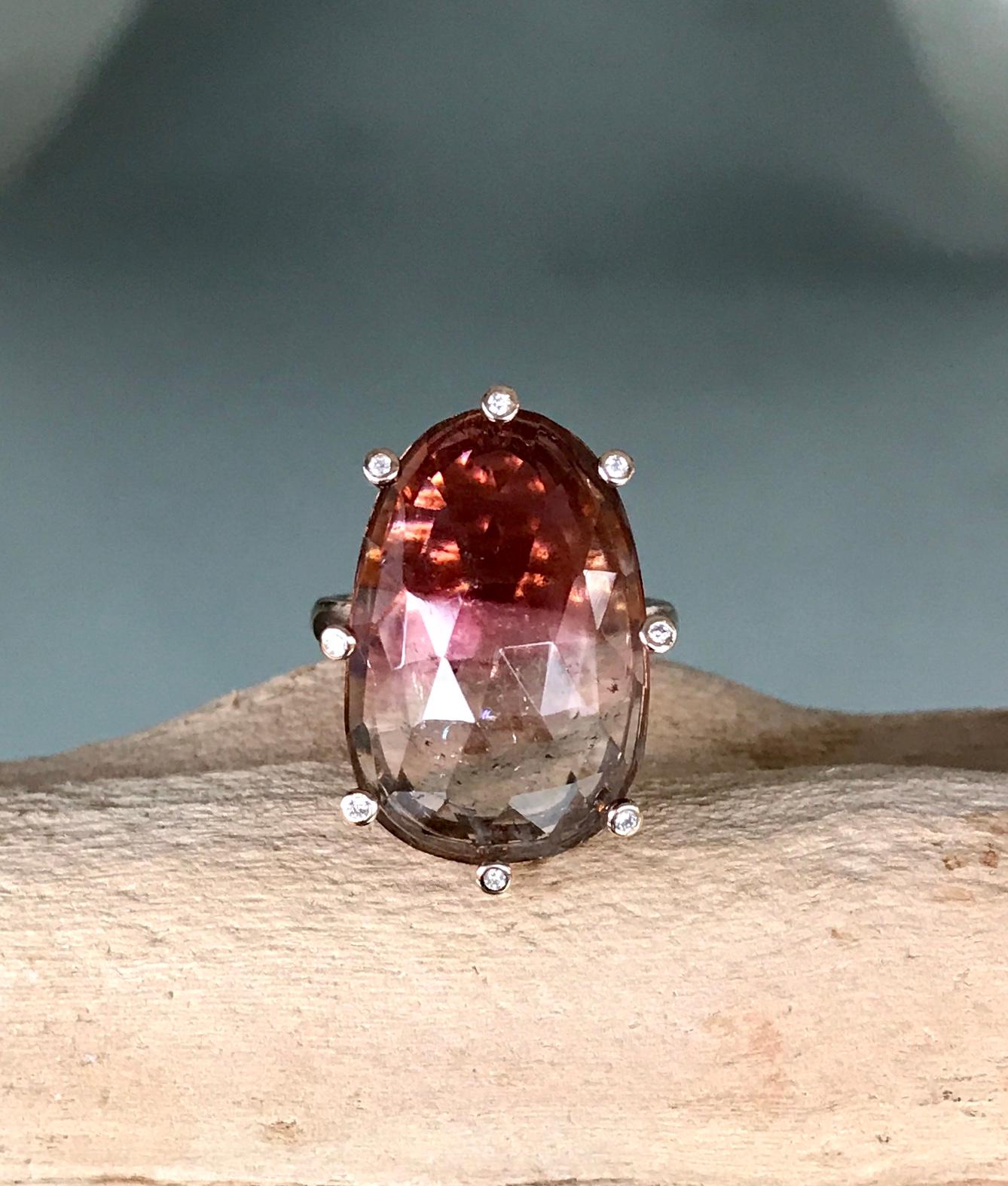 A rose-cut bicolor tourmaline solitaire cocktail ring highlighted with white diamond accents, handcrafted in 18 karat matte rose gold. US size 6.15.

This subtly beautiful one-of-a-kind bicolor ring radiates brilliant sparks of fire from within when