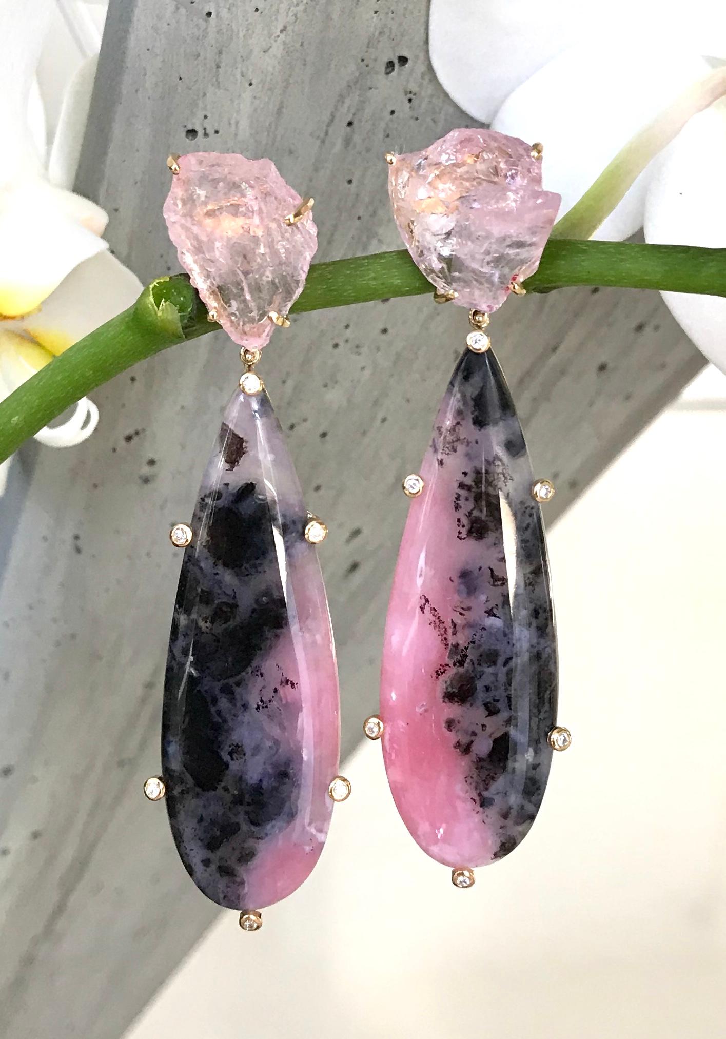 One-of-a-kind dangle earrings of rough pink morganites and cabochon pink opal drops with natural black matrix, accented by white diamonds. Handcrafted in 18 karat yellow gold.

These stunning pink and black earrings make a glamorous statement when