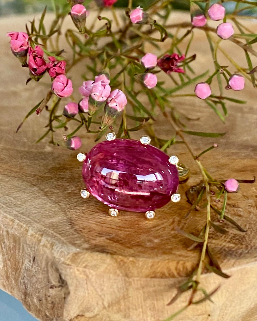 A rubellite tourmaline and diamond solitaire cocktail ring, handcrafted in 18 karat yellow gold.

This beautiful rubellite cabochon gemstone only needs diamond accents to highlight the natural luminous and translucent beauty of the gem. Simply