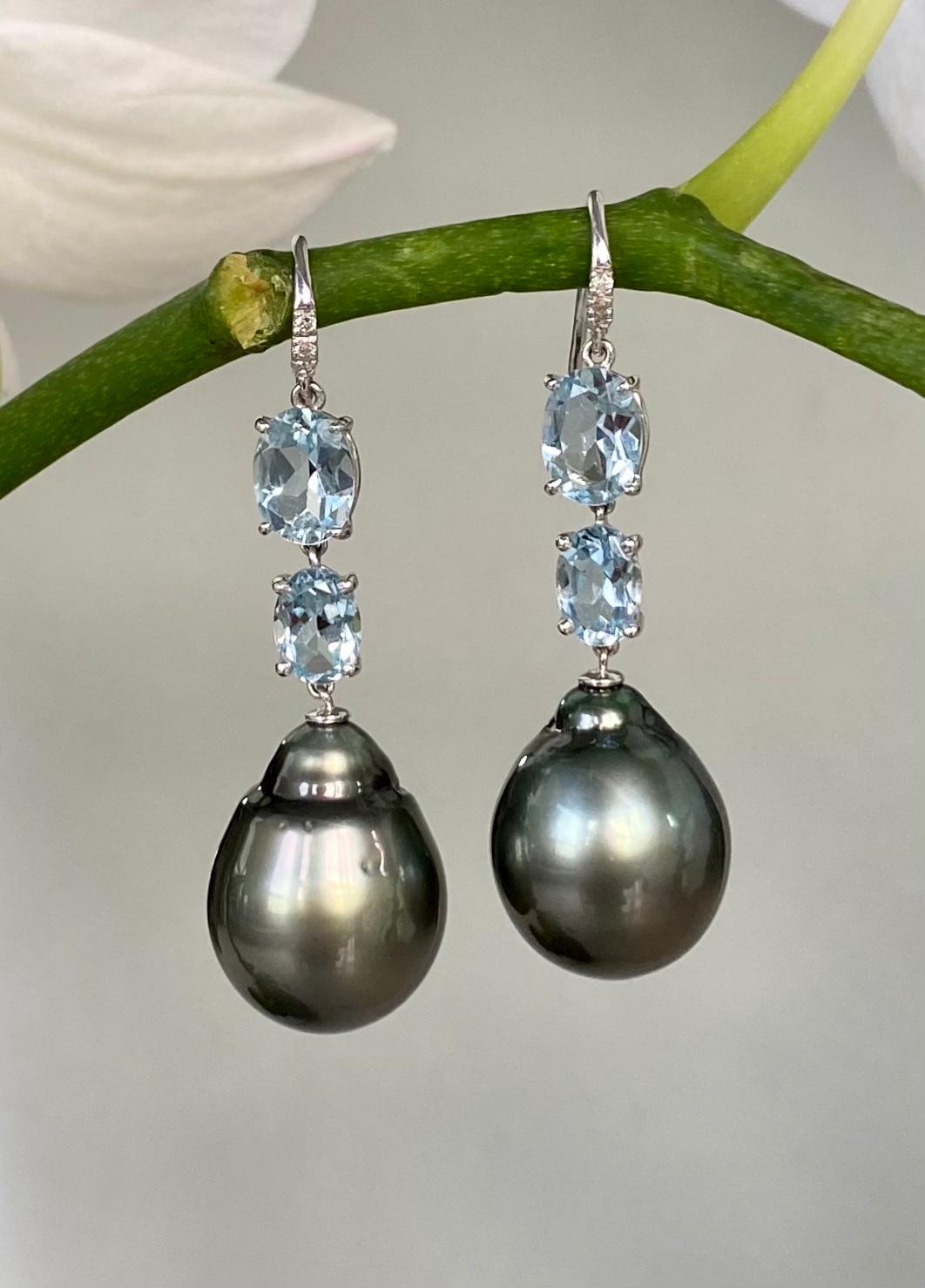 Black Tahitian pearls, faceted aquamarines and diamond dangle earrings, handcrafted in 18 karat white gold.

These exquisite one-of-a-kind black Tahitian baroque pearl earrings contrast with oval faceted aquamarines and diamonds to give you a