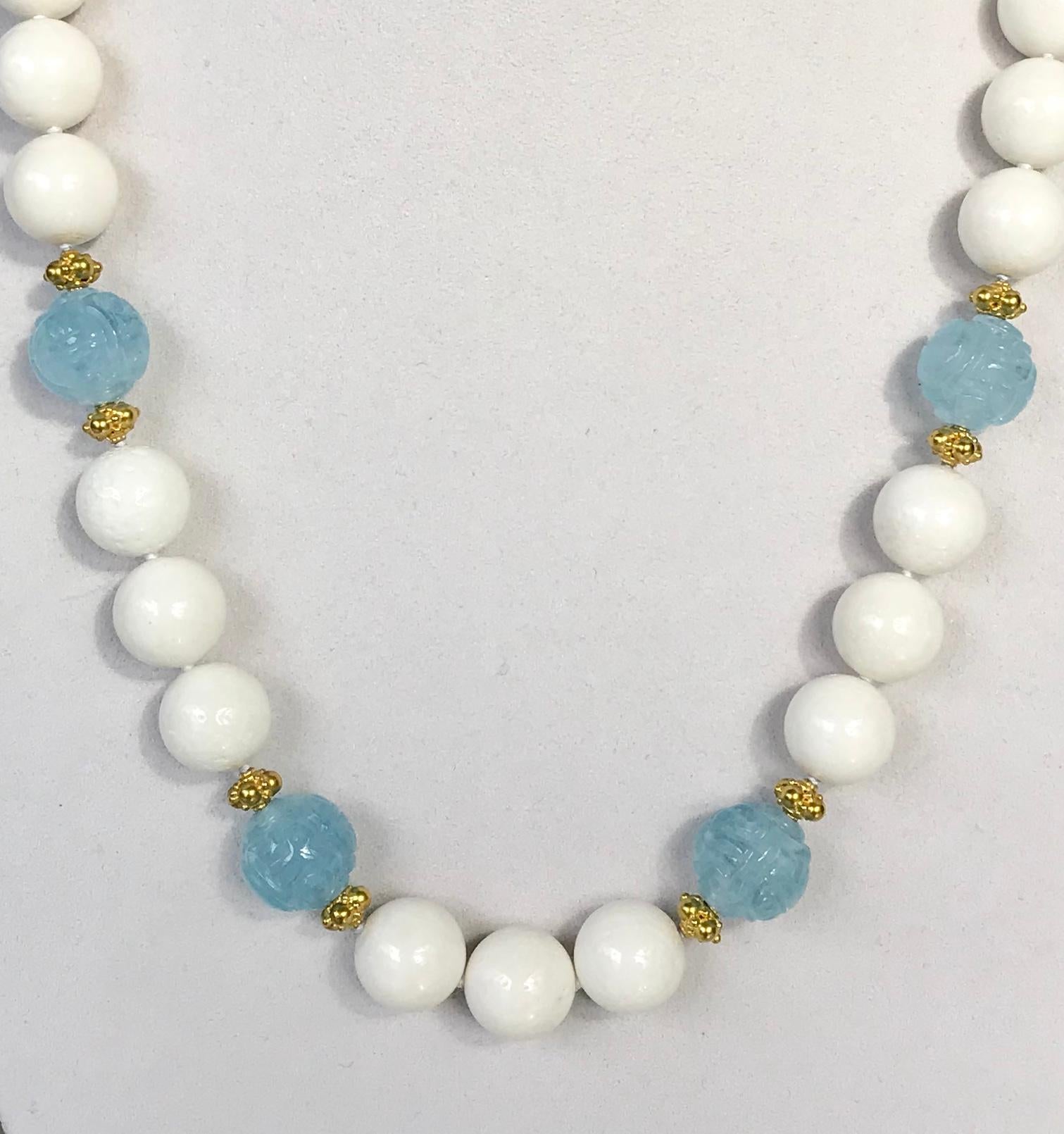 One-of-a-kind white coral beaded necklace accented with four carved aquamarine beads and eight 18 karat gold spacers and gold clasp.

A beautiful white coral beaded necklace interlaced with carved aquamarines and gold spacers, this refreshing