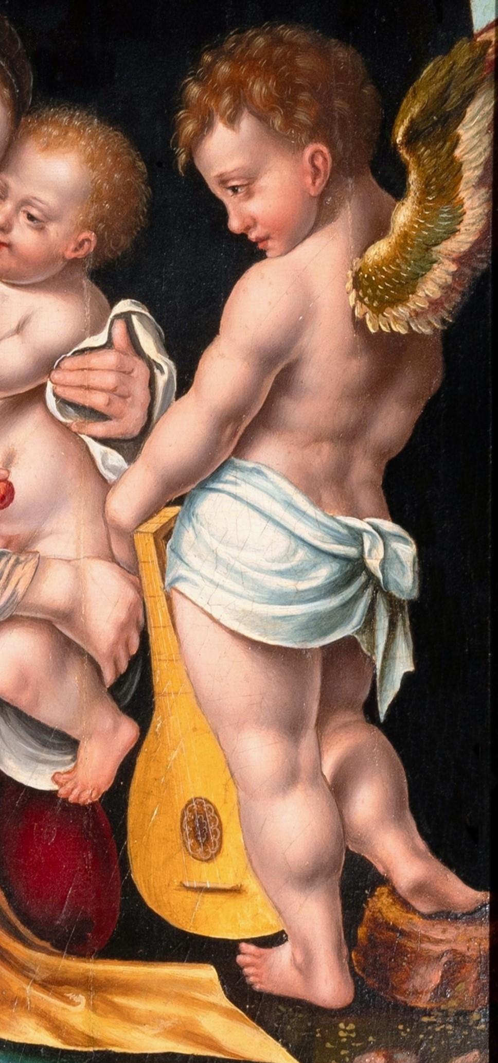 Madonna and child with angels, circle of Joos Van Cleve, 16th c. Antwerp school - Old Masters Painting by Joos van Cleve