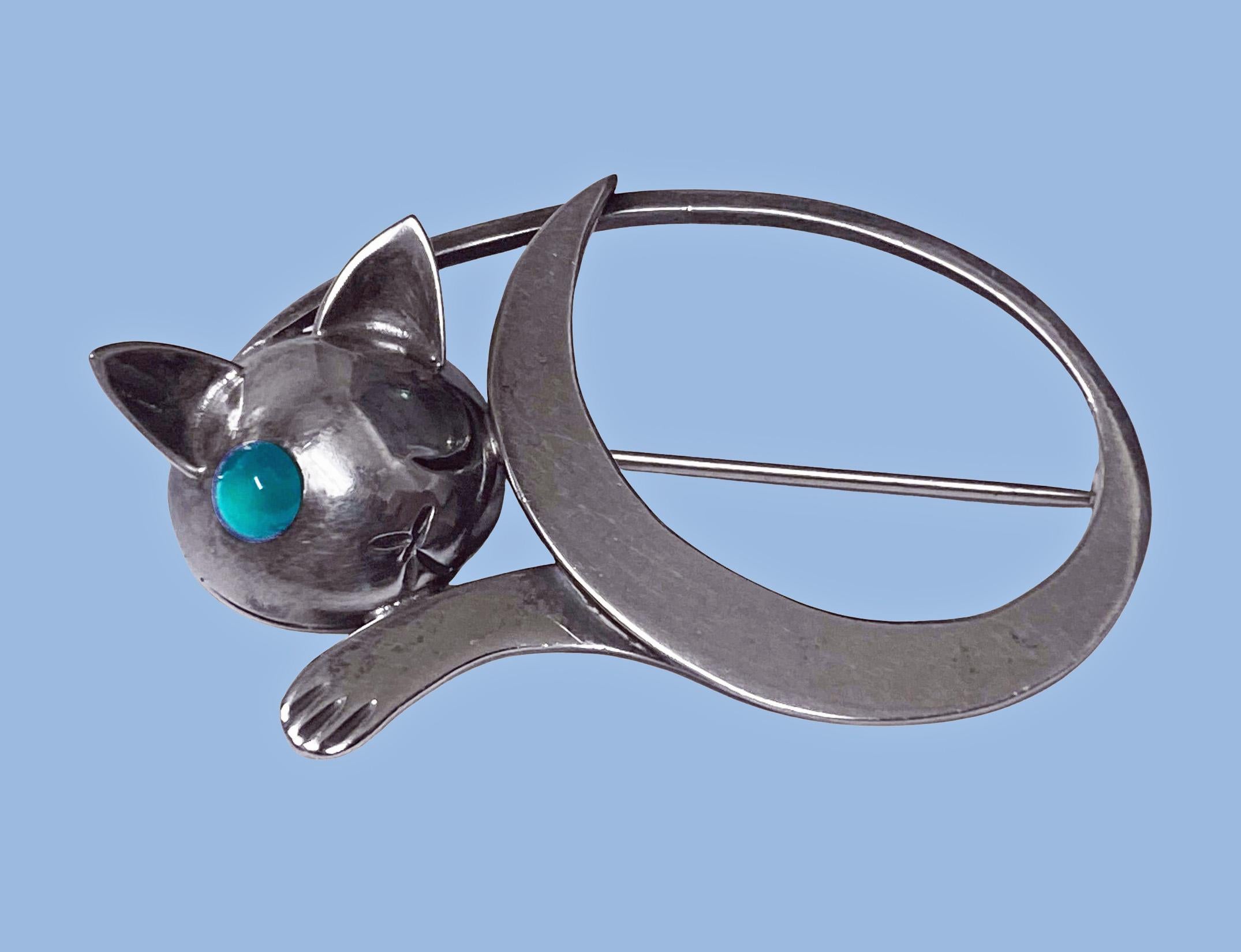 JoPol Sterling reclining Cat Brooch, modernist whimsical design, signed JoPol for Joan Polsdorfer C.1945. Polsdorfer was the first American jewelry designer and maker to work for Georg Jensen, USA. The cat's head brooch, with one eye closed and the