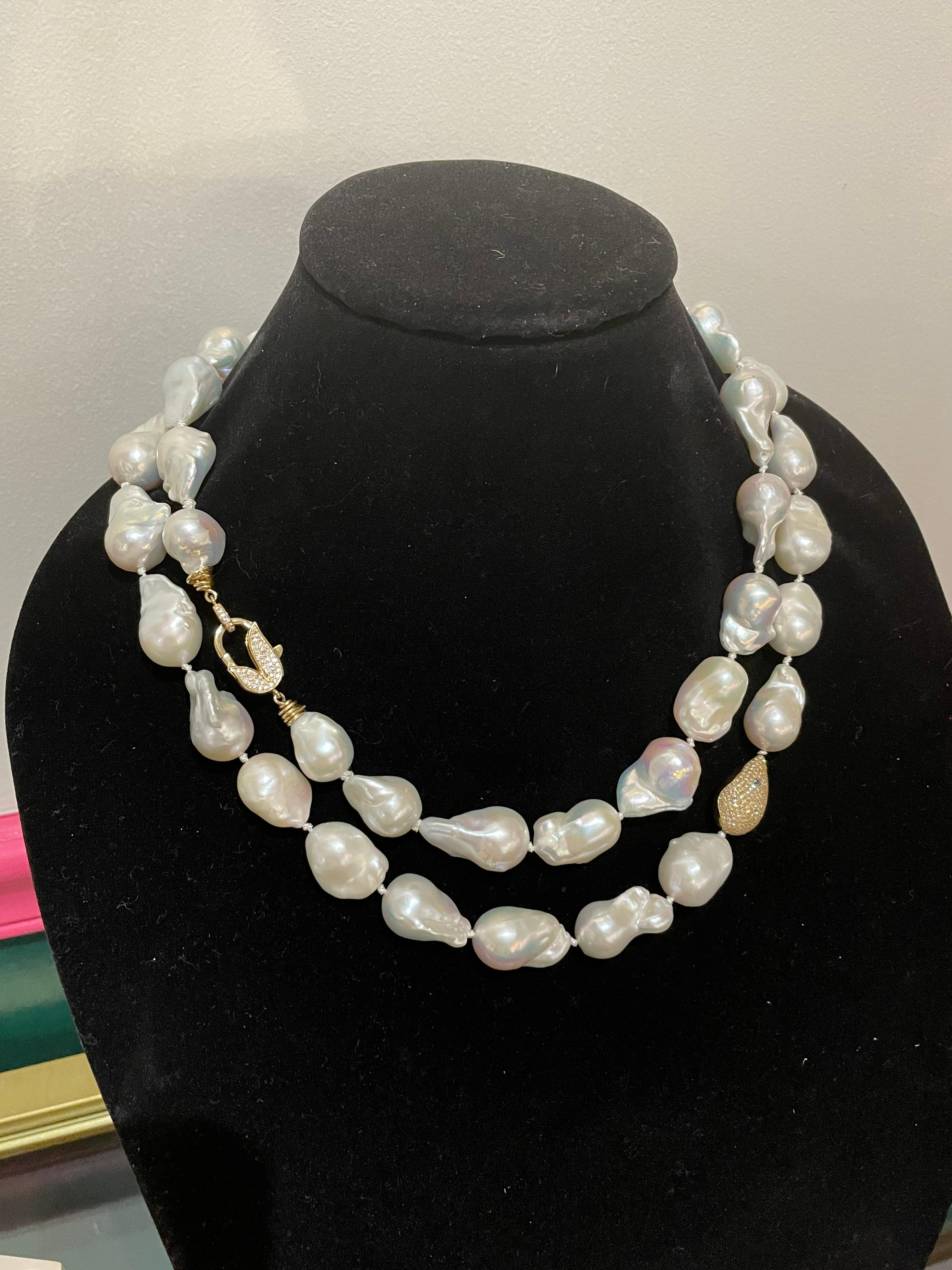 Long Baroque pearl necklace by rising star designer, Jordan Alexander. This unique necklace features extremely high quality pearls accented by 18kt gold and diamonds clasp and bead with a sapphire feature. This necklace can we worn doubled over or