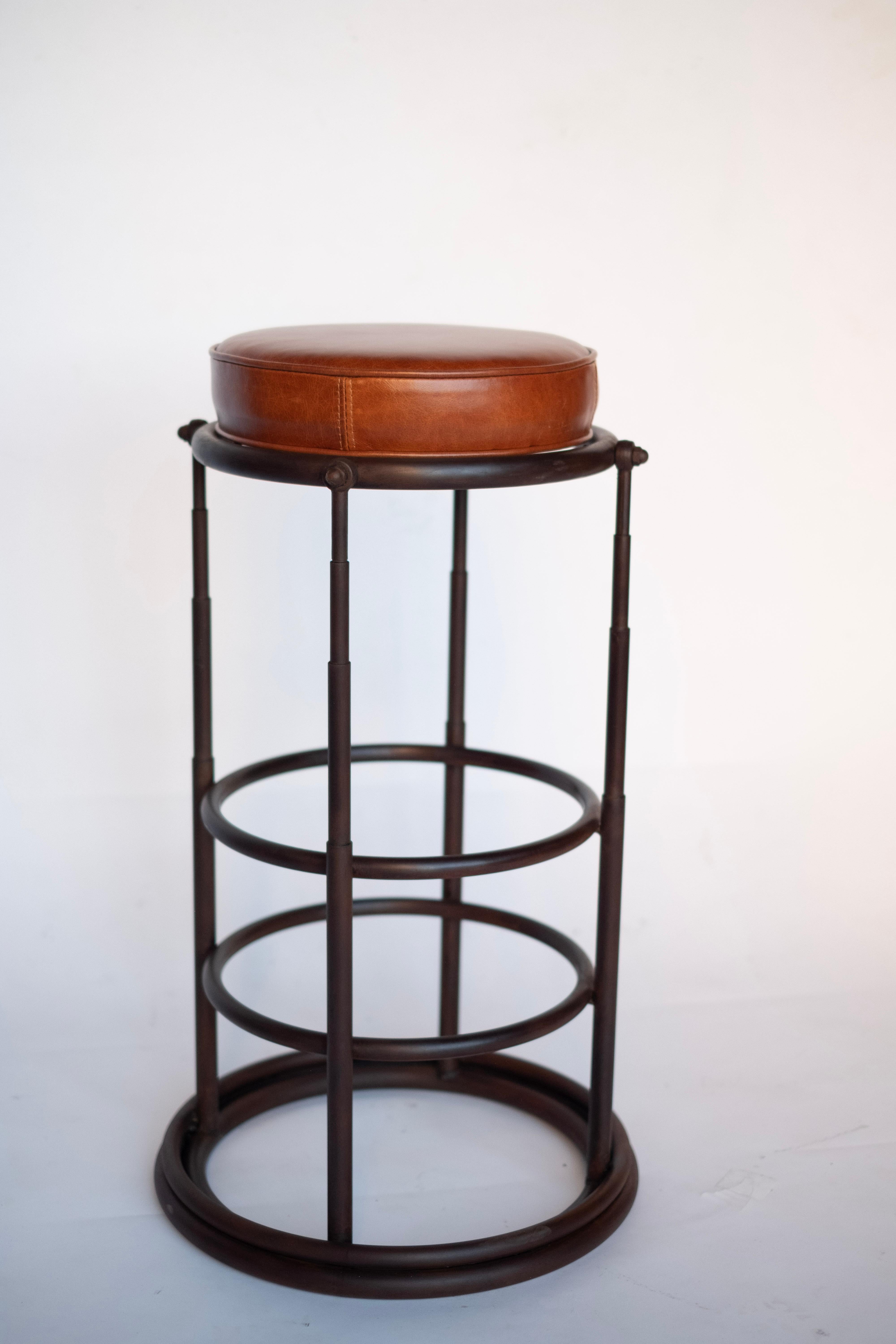 Jordan Mozer (b.1958): Cairo720 barstools, oxidized and clear coated cast steel and welded tubular steel structures with leather upholstered cushions, 1987-2019. Provenance: Collection of the artist. Signed. New. 
Measures: 16” diameter x 31” tall