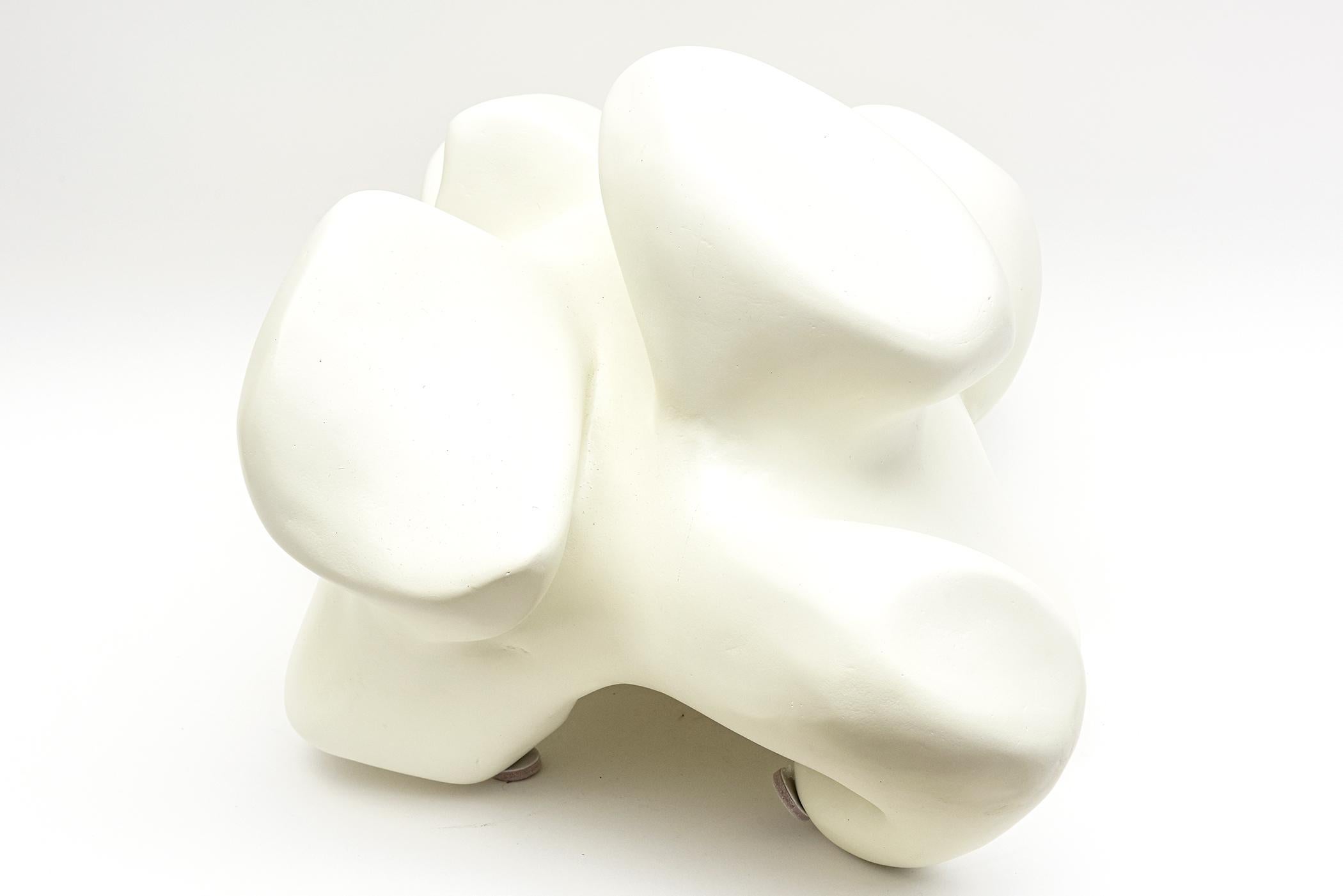 This most unusual off white fiberglass table top or wall mounted sculpture is by Jordan Mozer the designer of furniture and objects. It is from around 2012. It has protrusions of forms indifferent heights and shapes. As you turn it it changes