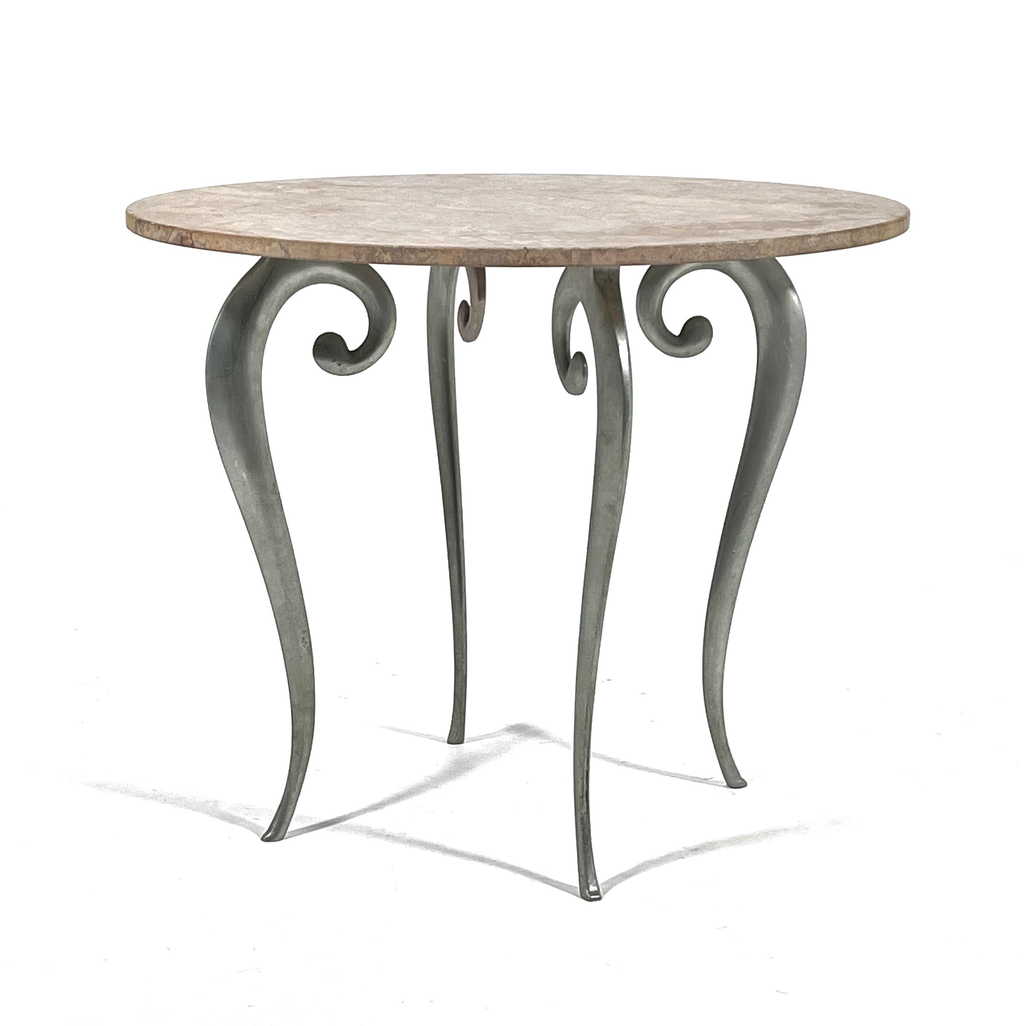 This elegant little table features a beautiful stone top with a highly figured pink and gray lunar stone and a base with cast aluminum legs. Possibly created by Judy Niedermaier,  the exuberant seahorse shaped legs are reminiscent of the work of