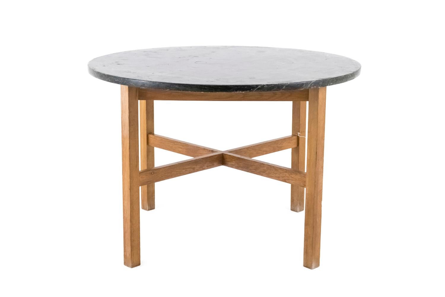 Jordi Casanblancas Muntañola, in the style of.

Circular table in beechwood and green marble standing on four square legs linked between them by a cross stretcher. Apron composed of four crossbars slighly behind the leg line supporting the